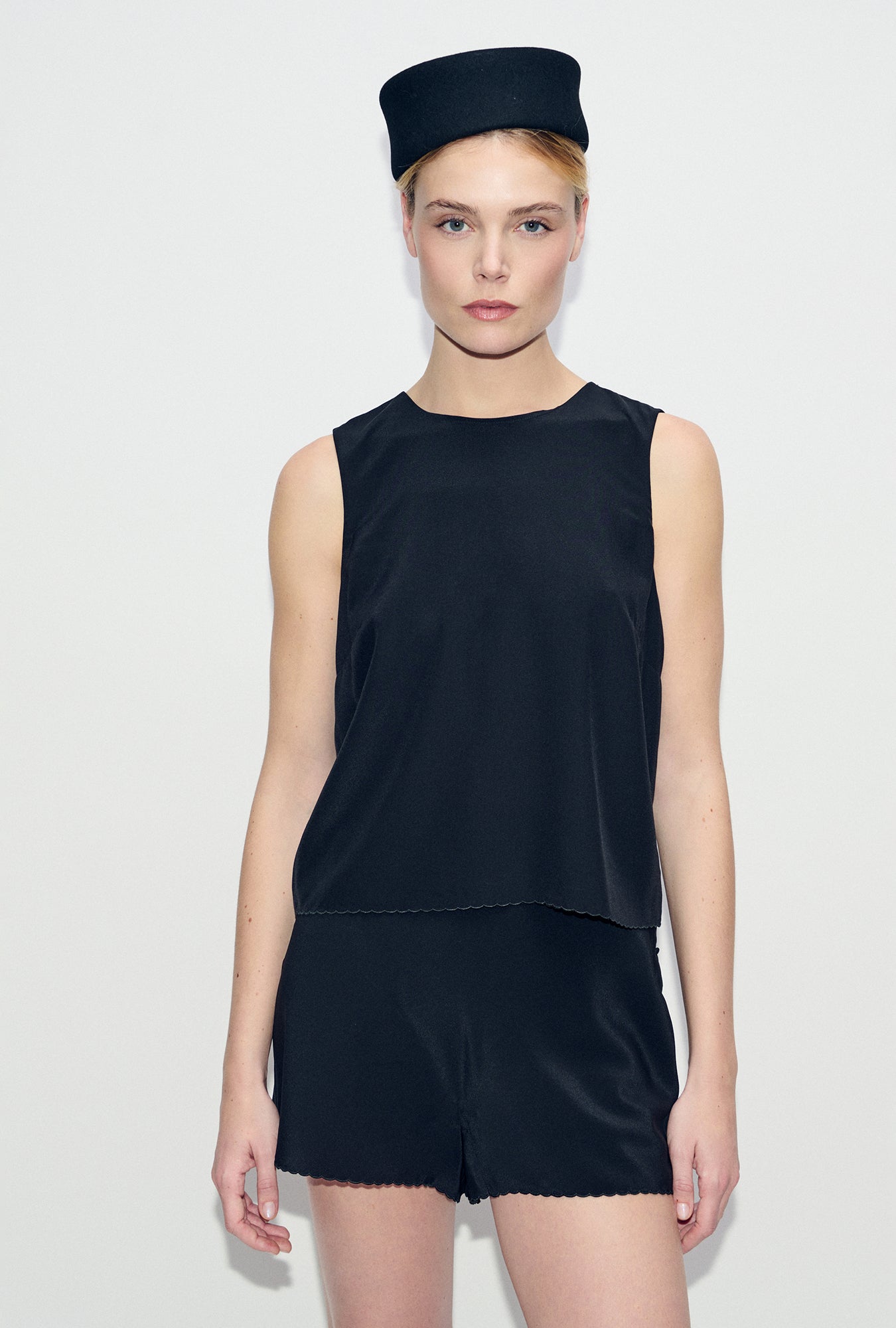 Image of a model wearing Shorts. Product name - CDC Scallop Shorts Black in Black colour by brand - Silk Laundry