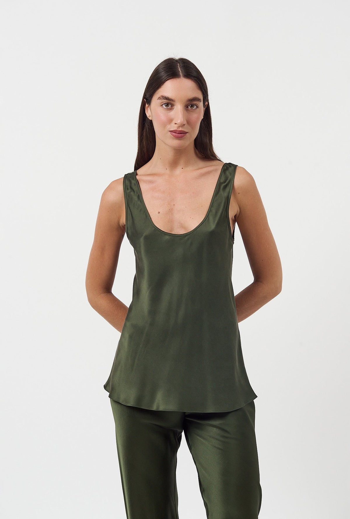 Image of a model wearing Tops. Product name - Scoop Neck Tank Cedar in Cedar colour by brand - Silk Laundry