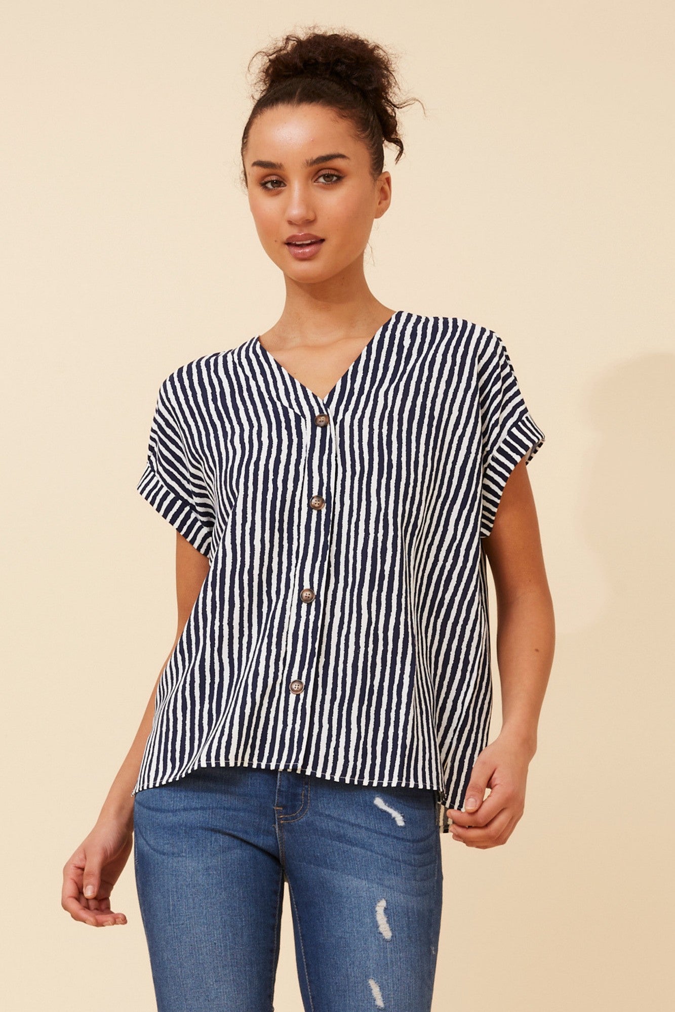 Image of a model wearing Tops. Product name - INOLA STRIPE PRINT TOP in Navy colour by brand - Stella