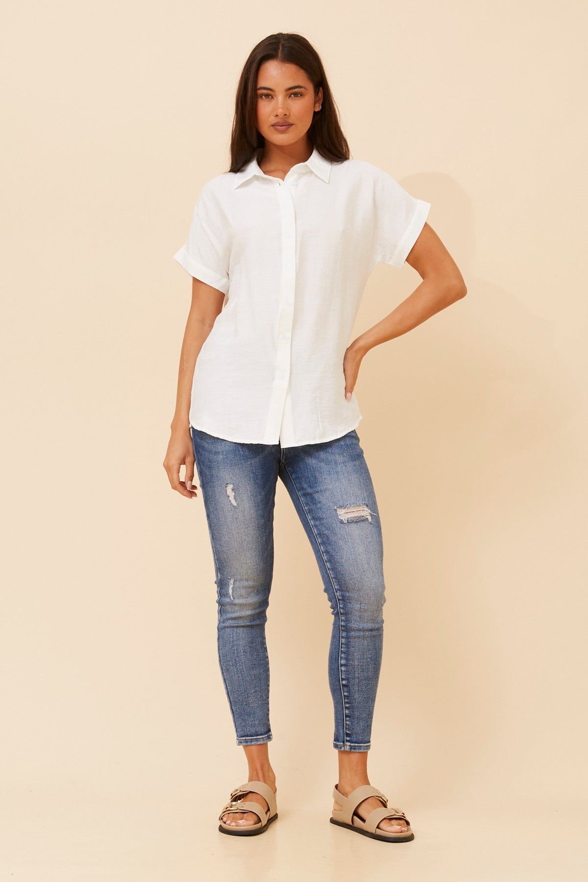 Image of a model wearing Shorts. Product name - ZIPPORAH SHORT SLEEVES TOP in Black colour by brand - Caroline Morgan Australia