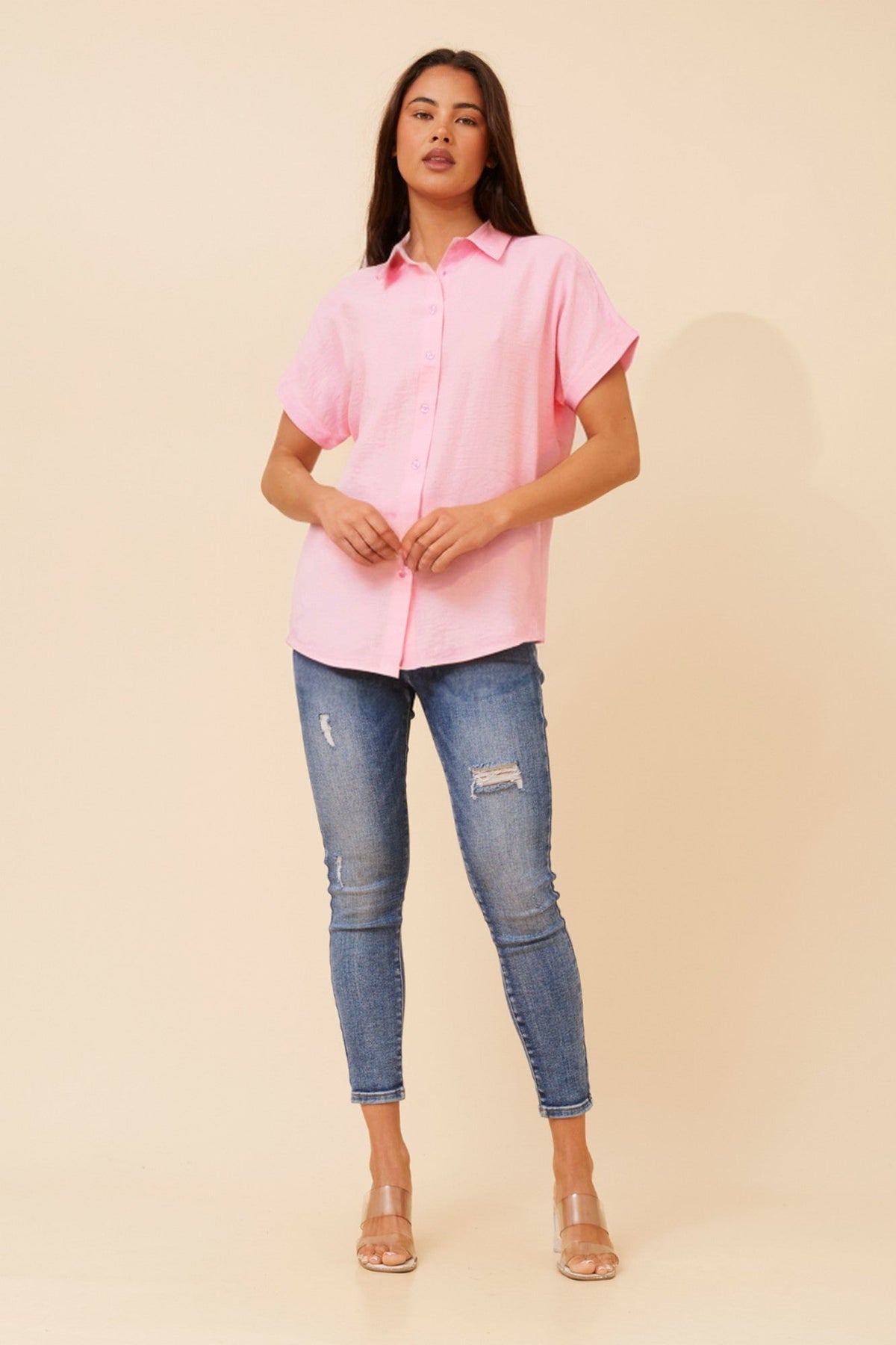 Image of a model wearing Shorts. Product name - ZIPPORAH SHORT SLEEVES TOP in Black colour by brand - Caroline Morgan Australia