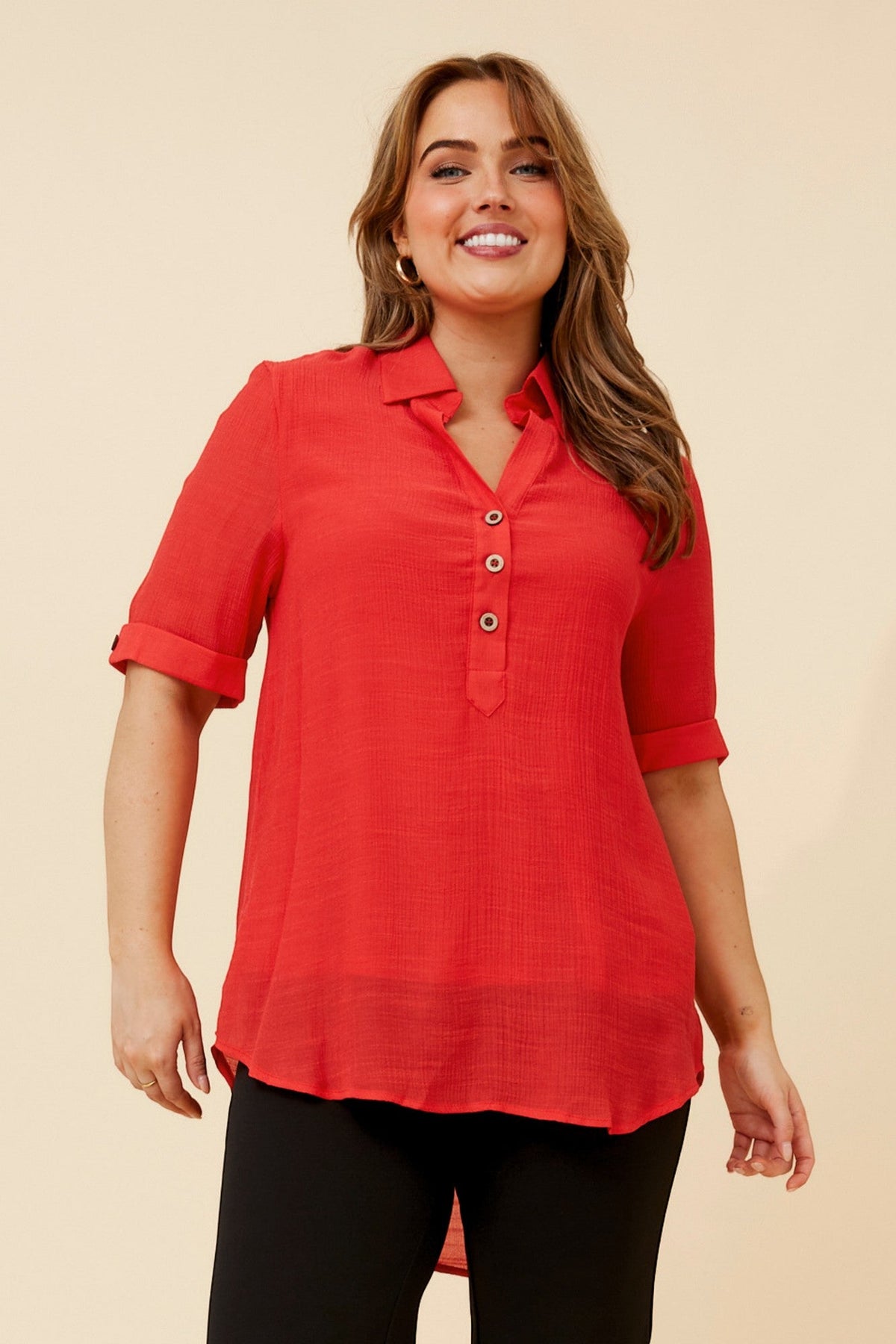 Image of a model wearing Tops. Product name - IRINI SOLID TOP in Red colour by brand - Caroline Morgan Australia