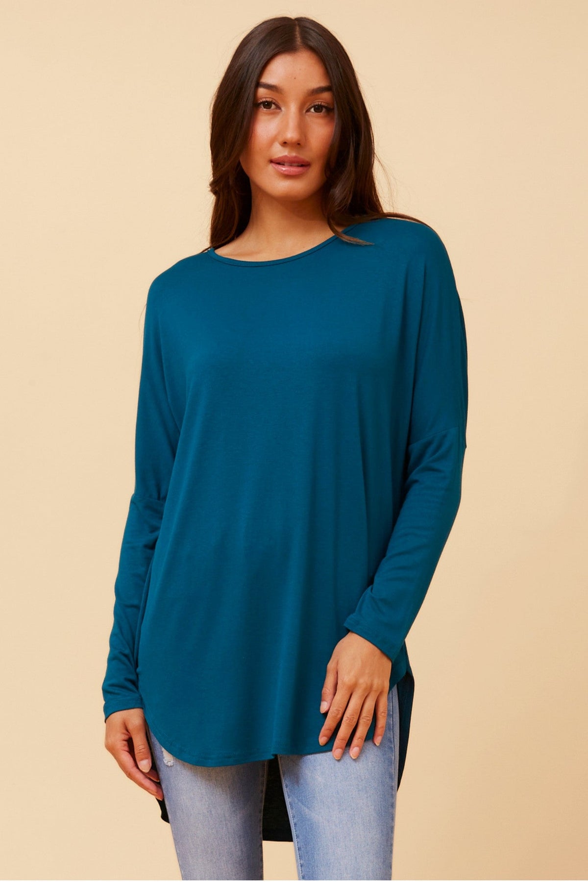 Image of a model wearing Tops. Product name - SKYE SOLID TOP in Teal colour by brand - Caroline Morgan Australia