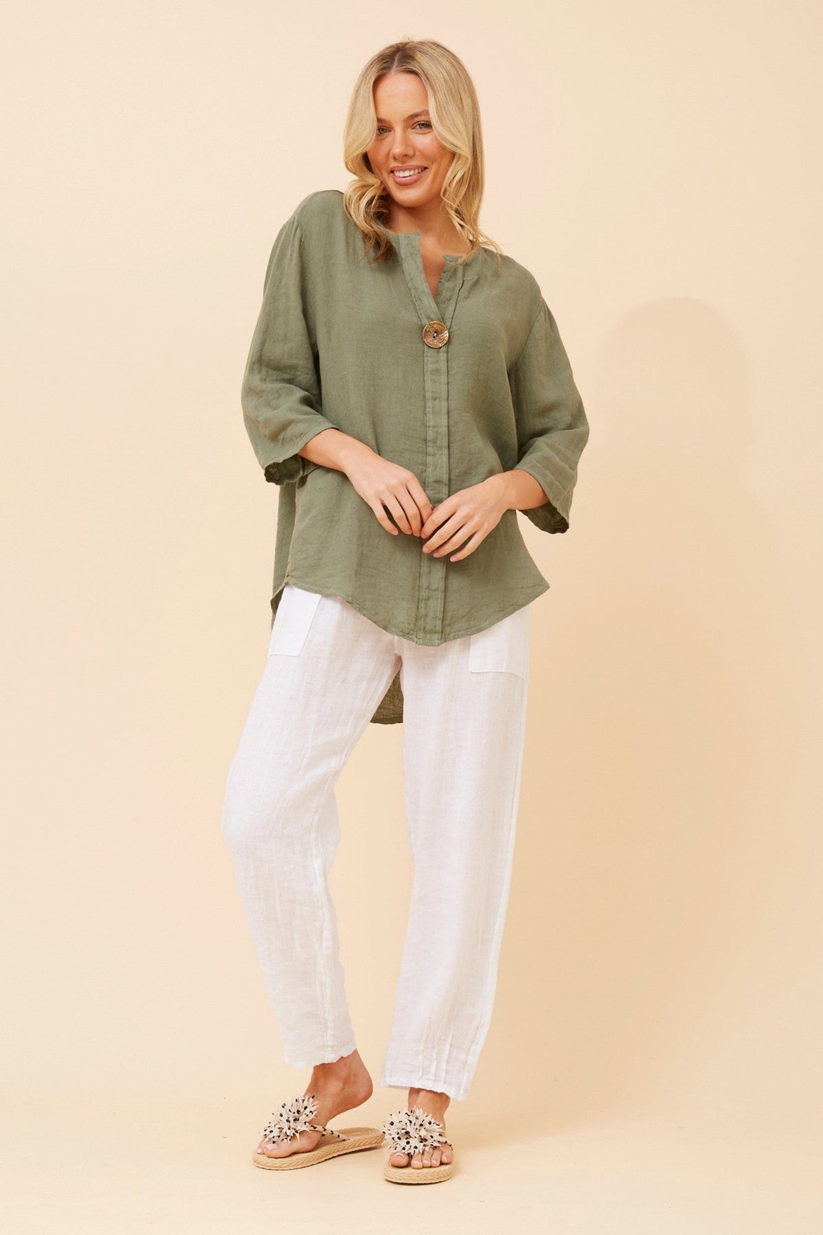 Image of a model wearing Tops. Product name - PALERMO LINEN TOP in Khaki colour by brand - BOTTEGA MODA