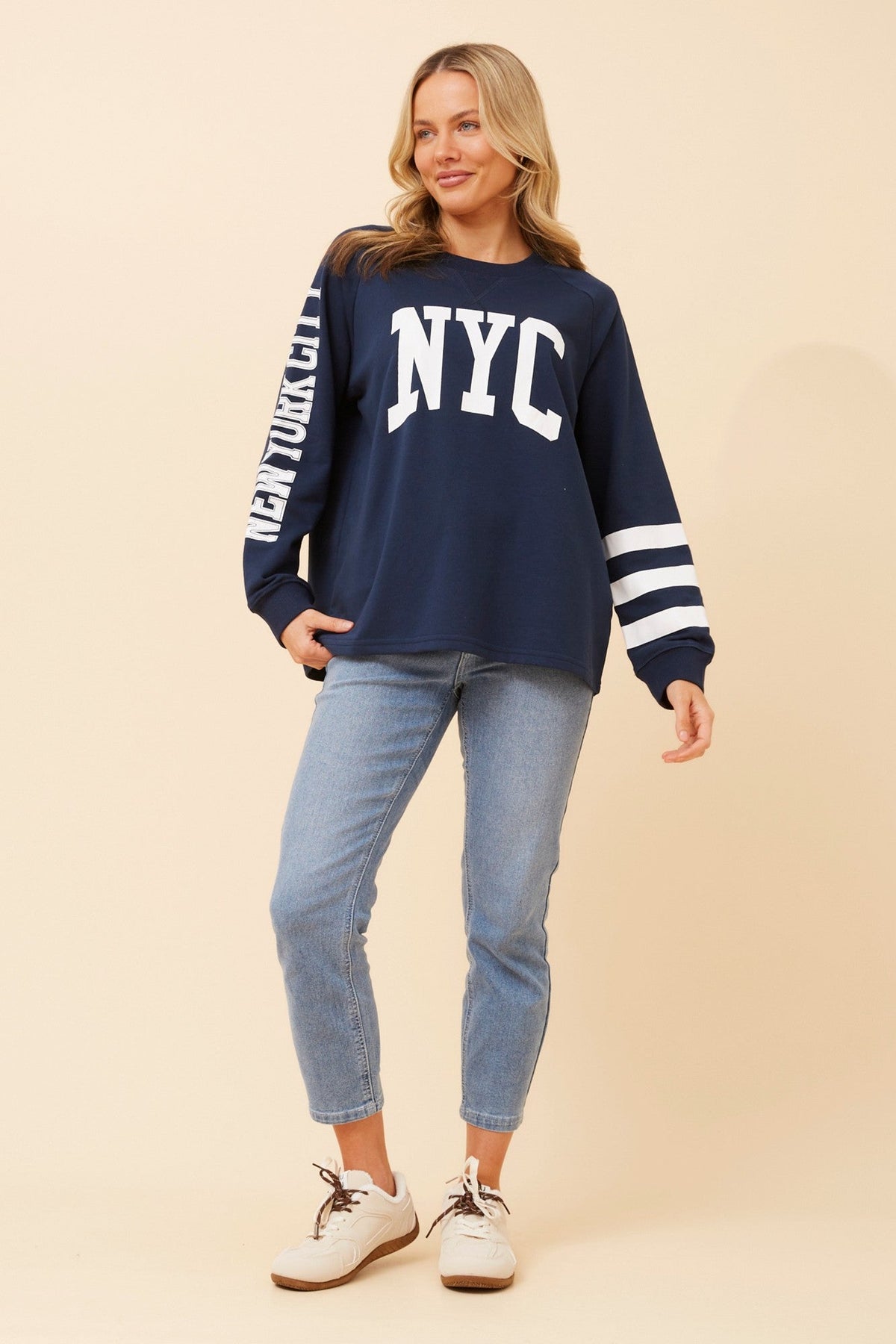 Image of a model wearing Tops. Product name - HUETTE GRAPHIC PRINT TOP in Blue Jean colour by brand - Caroline Morgan Australia