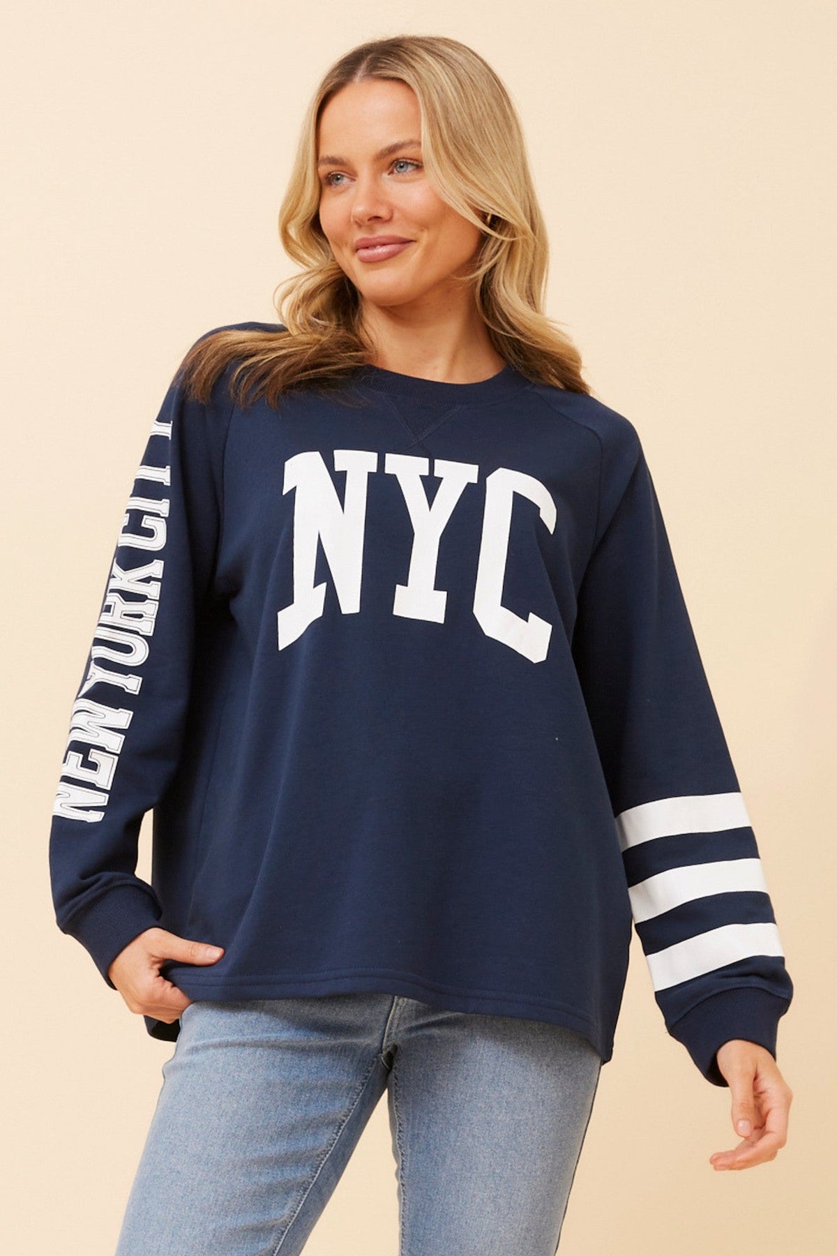 Image of a model wearing Tops. Product name - HUETTE GRAPHIC PRINT TOP in Navy colour by brand - Caroline Morgan Australia
