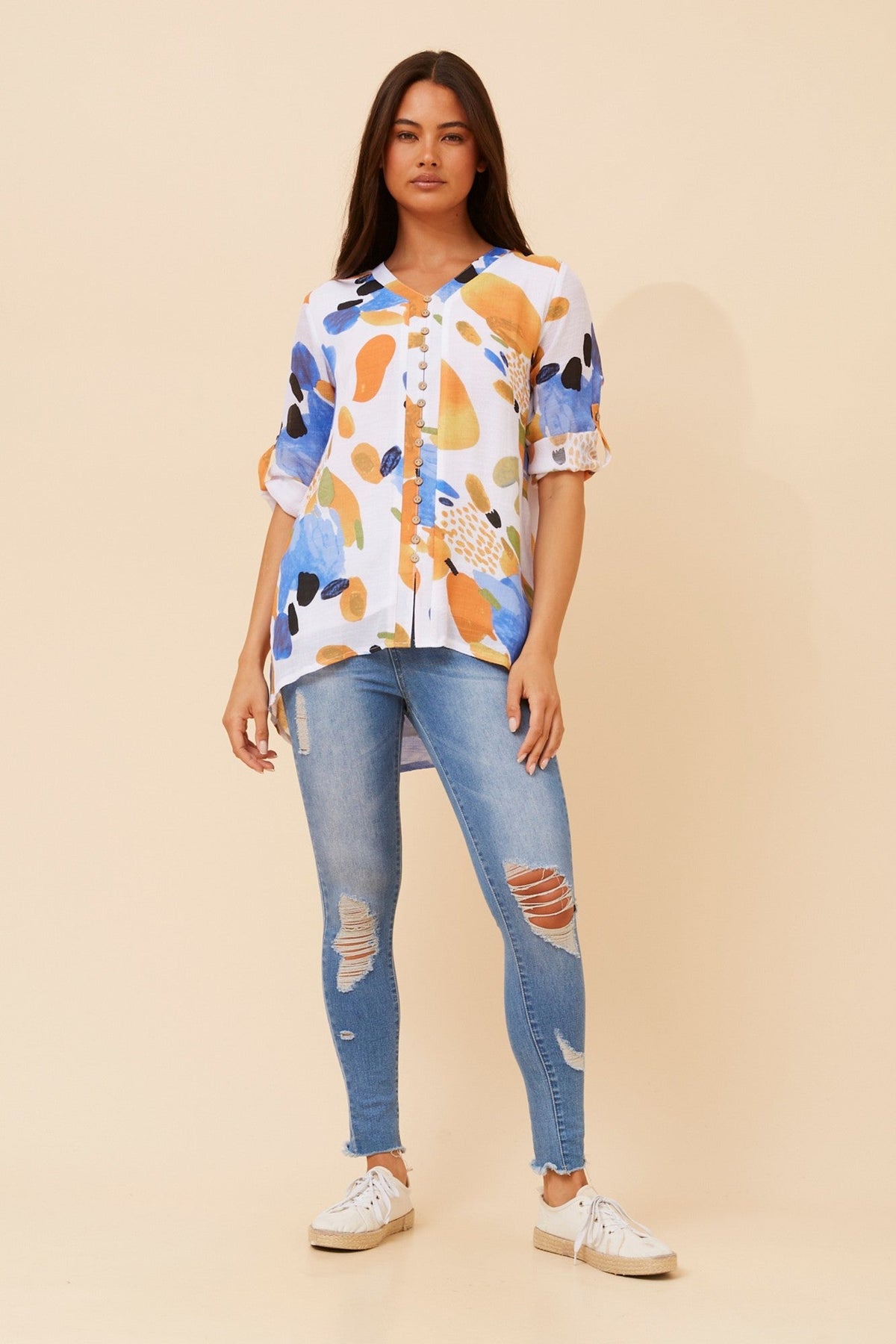 Image of a model wearing Tops. Product name - RUBY ABSTRACT PRINT TOP in Multi Blue colour by brand - Caroline Morgan Australia