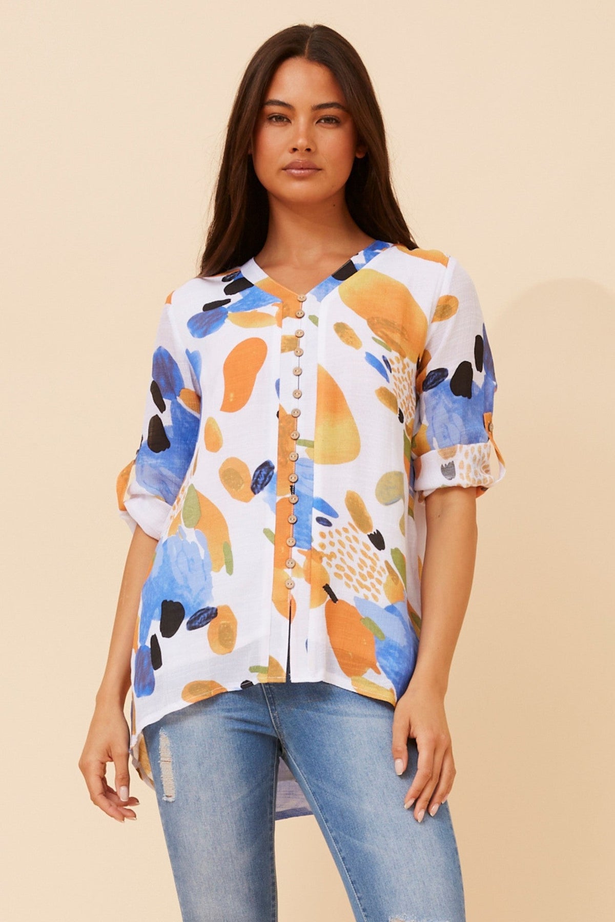 Image of a model wearing Tops. Product name - RUBY ABSTRACT PRINT TOP in Multi Orange colour by brand - Caroline Morgan Australia