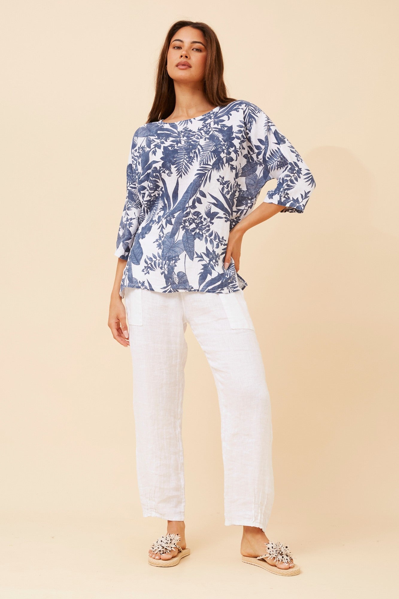 Image of a model wearing Tops. Product name - GIRALDA LEAF PRINT LINEN TOP in Multi White colour by brand - BOTTEGA MODA
