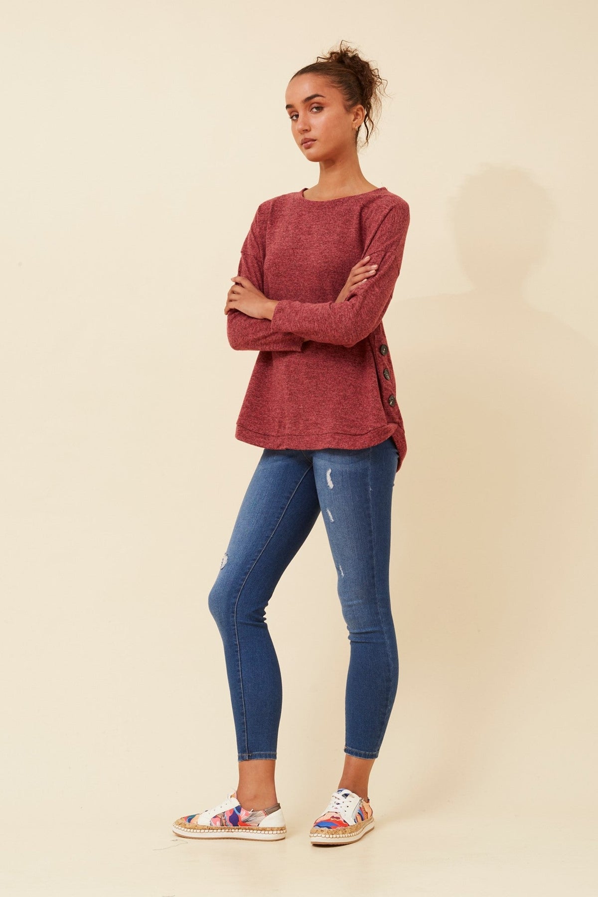Image of a model wearing Tops. Product name - EVAN BUTTON DETAIL TOP in Navy colour by brand - Caroline Morgan Australia