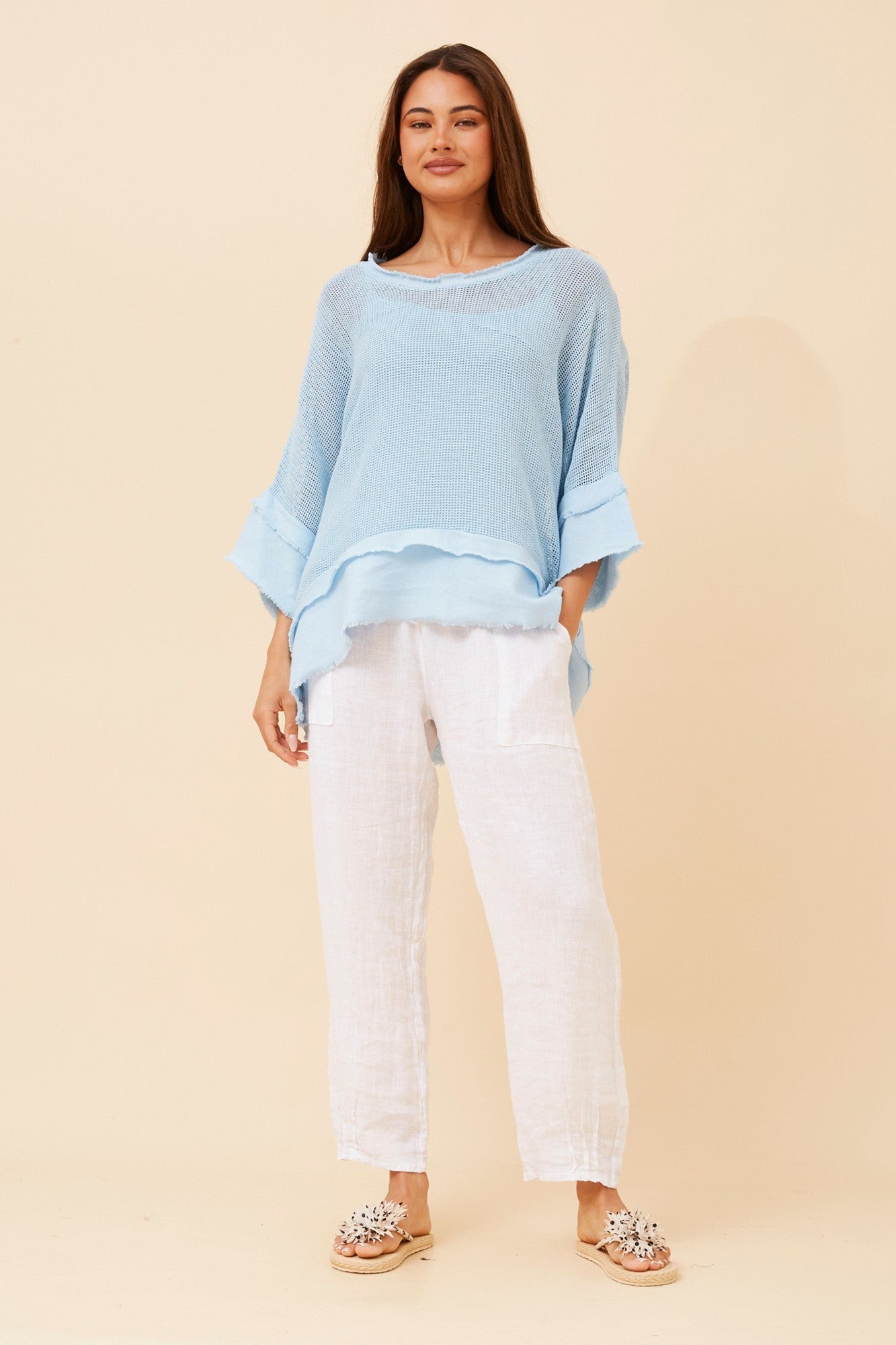 Image of a model wearing Tops. Product name - ROSAMUND RAW EDGE TOP in White colour by brand - BOTTEGA MODA
