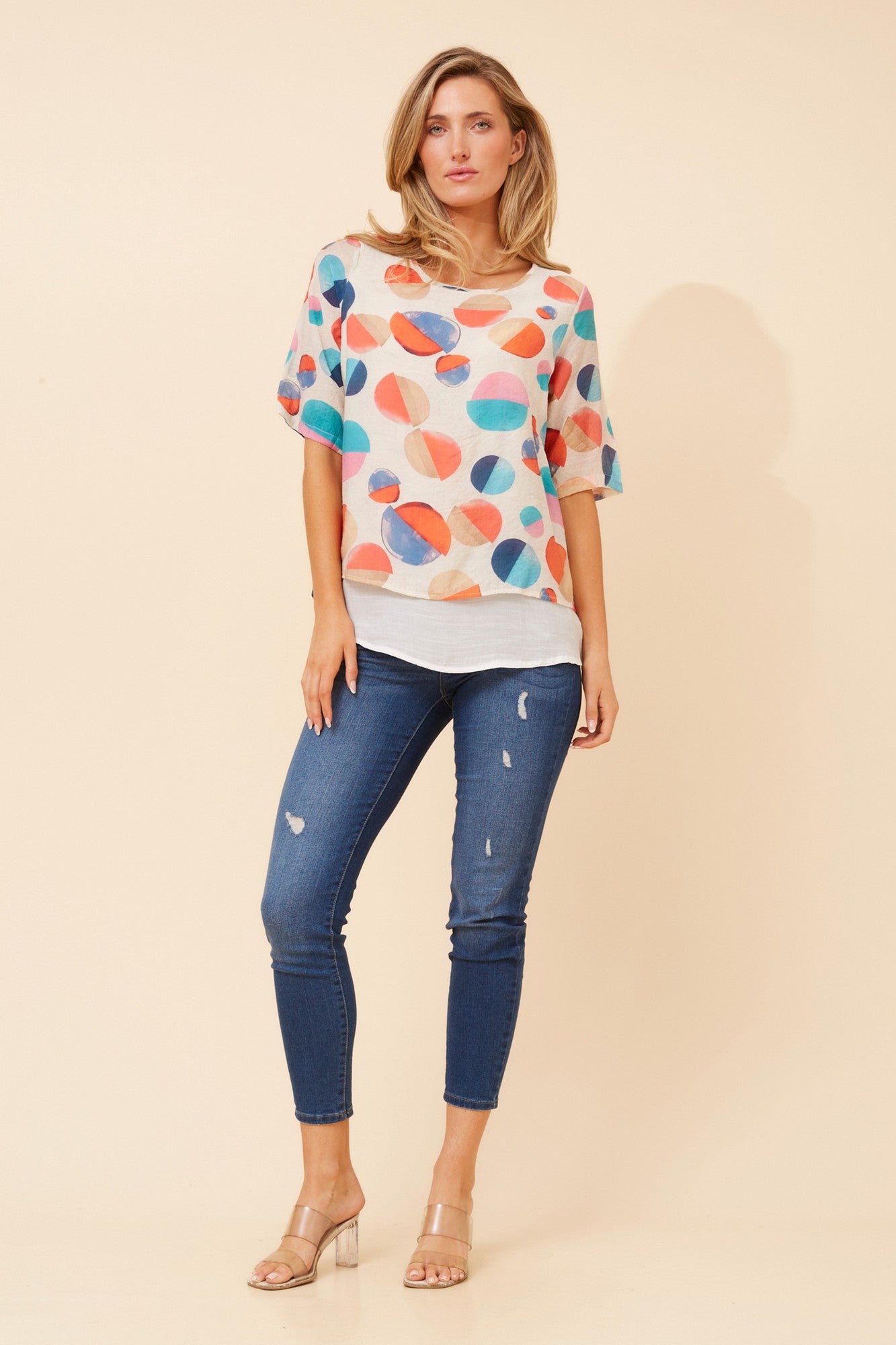 Image of a model wearing Tops. Product name - GLORY POLKA DOT PRINT TOP in Multi Orange colour by brand - Caroline Morgan Australia