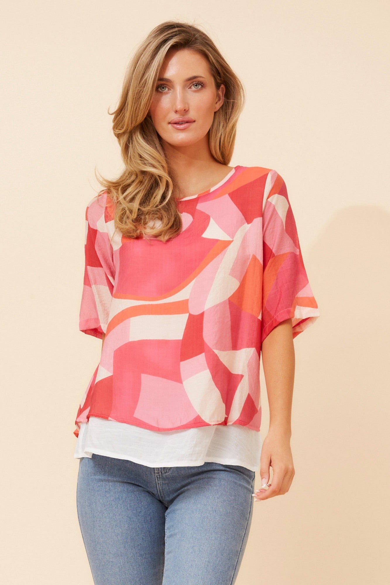 Image of a model wearing Tops. Product name - GLORY ABSTRACT PRINT TOP in Pink colour by brand - Caroline Morgan Australia