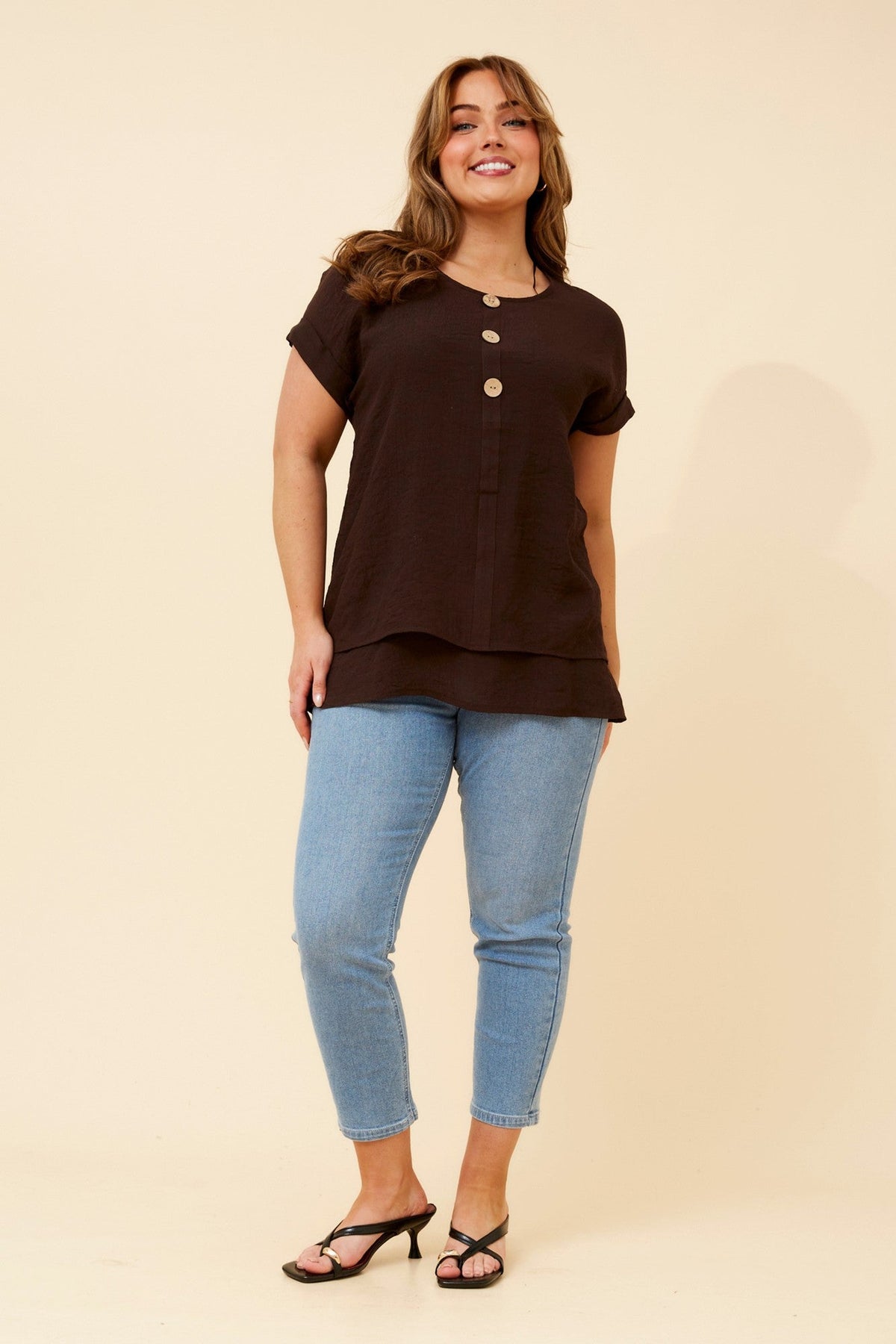 Image of a model wearing Tops. Product name - JAYCEE SOLID TOP in Bitter Chocolate colour by brand - Caroline Morgan Australia