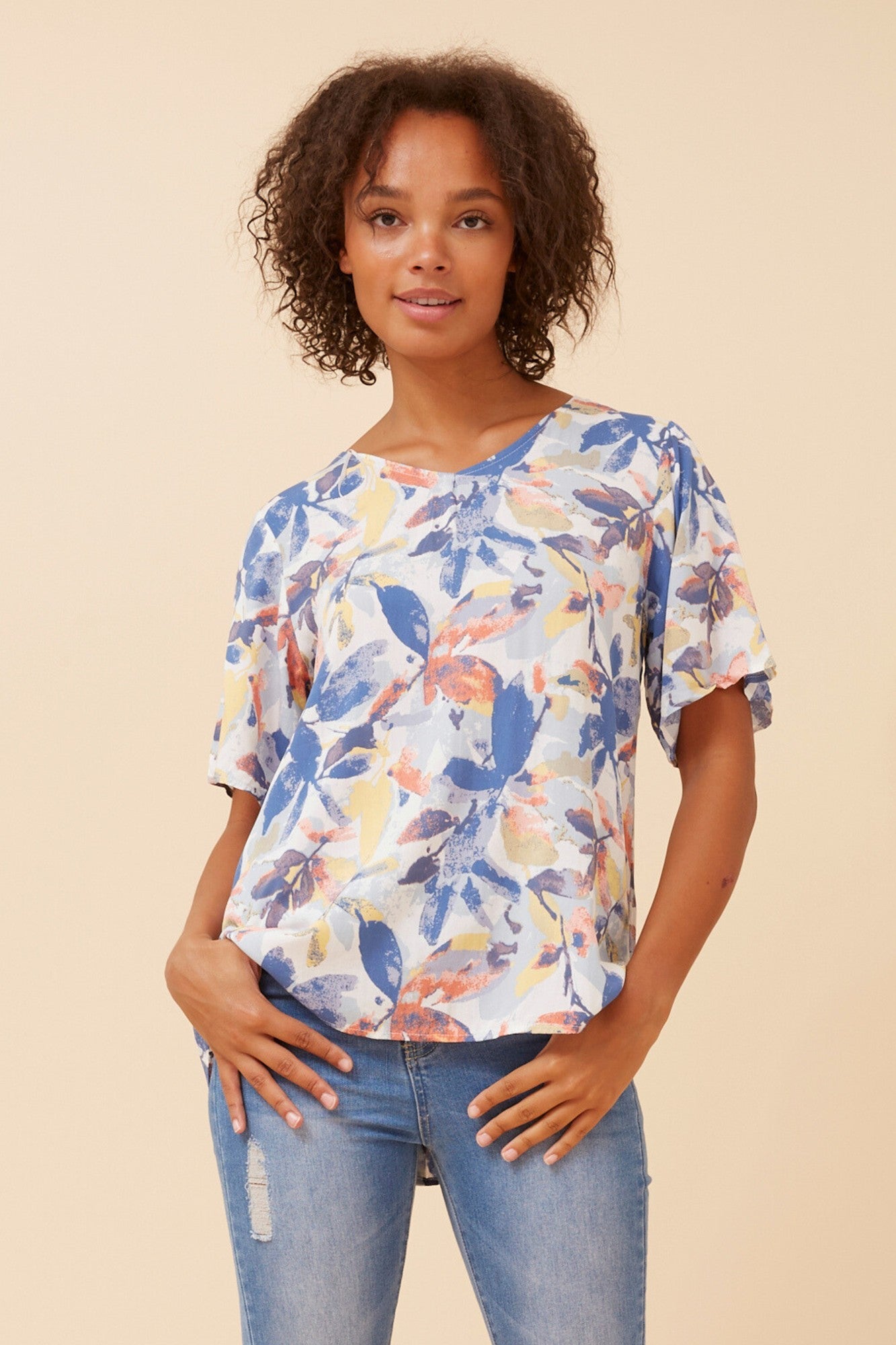 Image of a model wearing Tops. Product name - SONIA LEAF PRINT TOP in Multi Blue colour by brand - Caroline Morgan Australia