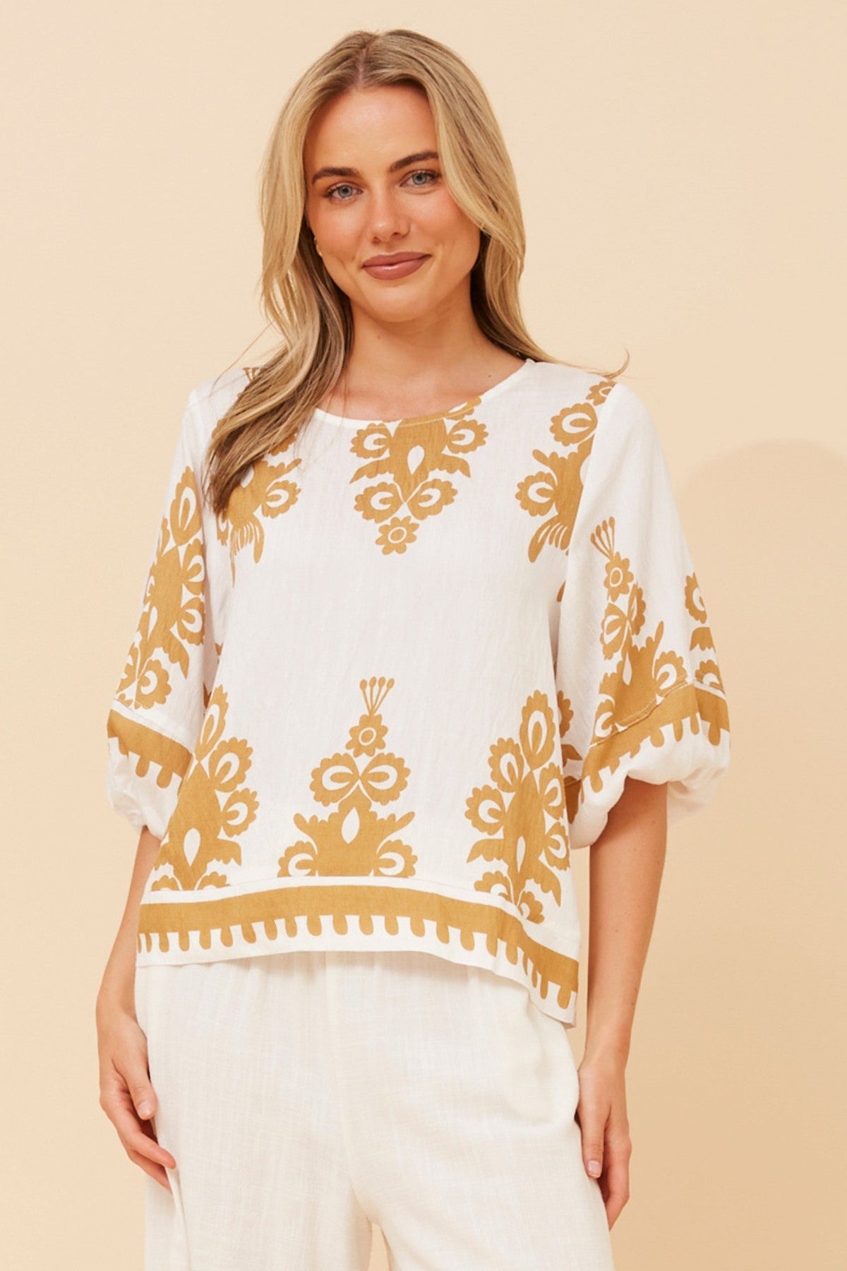 Image of a model wearing Tops. Product name - LIESL BORDER PRINT TOP in Beige colour by brand - Caroline Morgan Australia