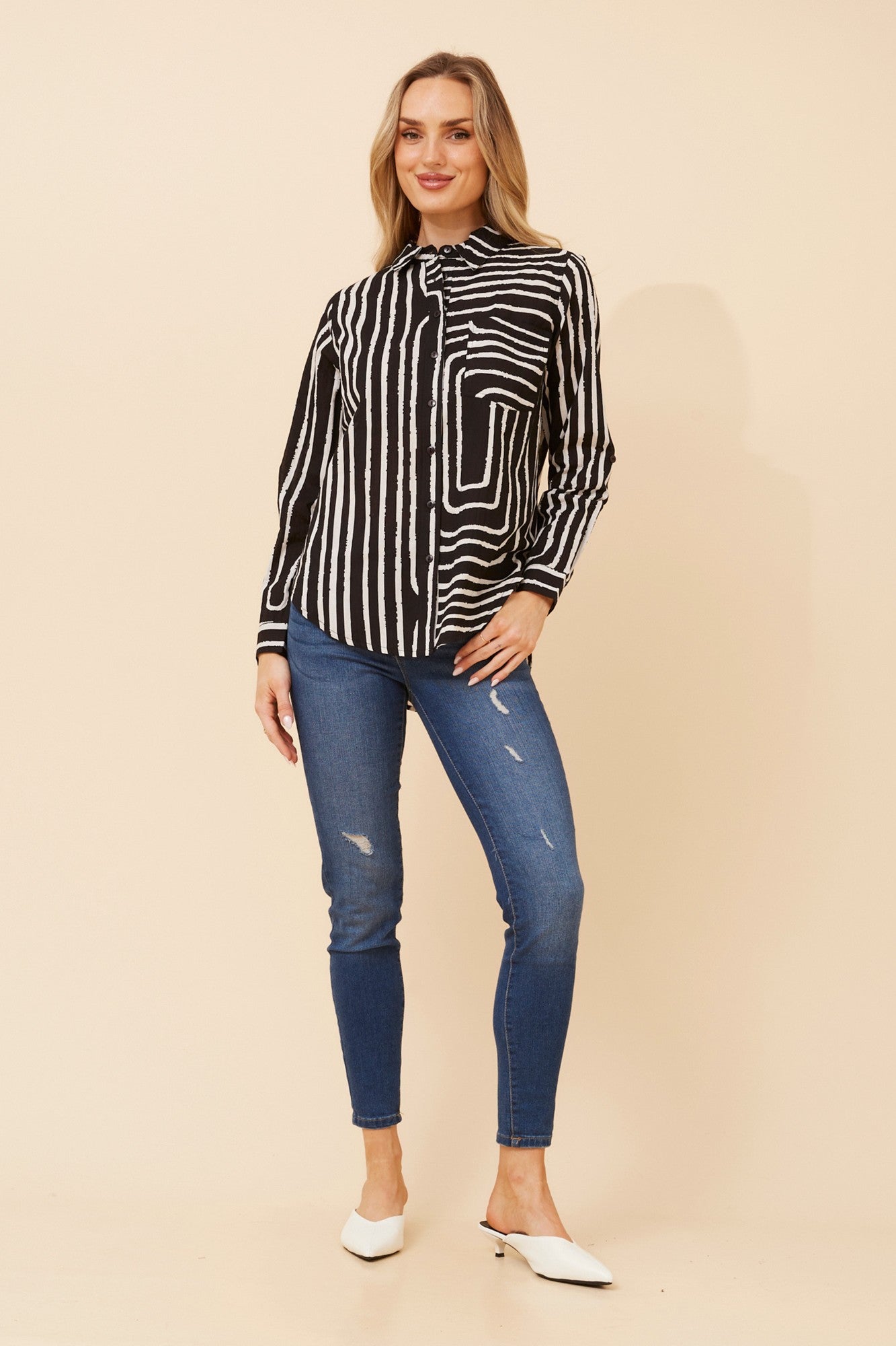 Image of a model wearing Tops. Product name - MARGARET STRIPE PRINT TOP in Black colour by brand - MYSTIC MONSOON