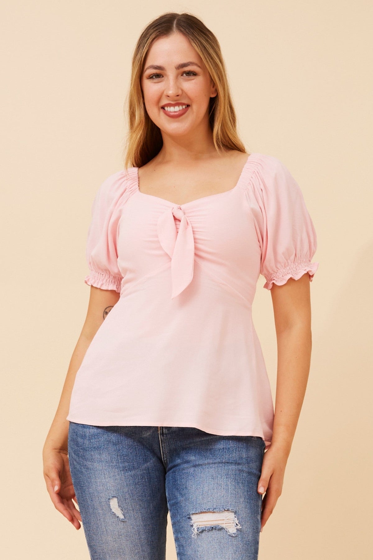 Image of a model wearing Tops. Product name - ZAIA SOLID TOP in Powder Pink colour by brand - Caroline Morgan Australia