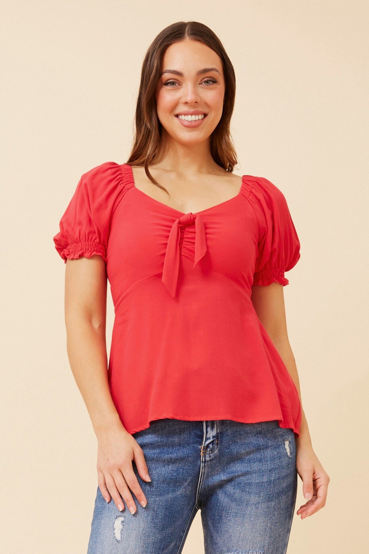 Image of a model wearing Tops. Product name - ZAIA SOLID TOP in Red colour by brand - Caroline Morgan Australia