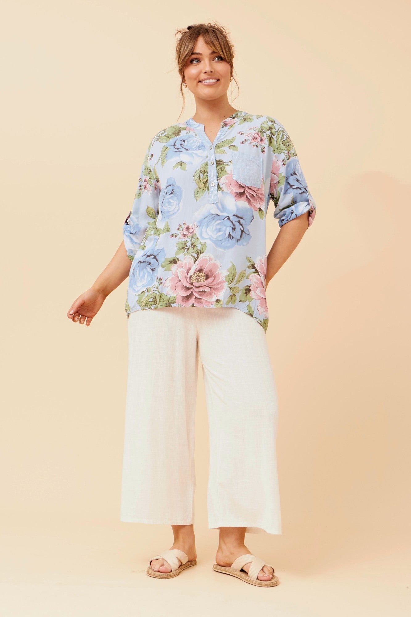 Image of a model wearing Tops. Product name - ROSETTA FLORAL PRINT TOP in Light Blue colour by brand - BOTTEGA MODA