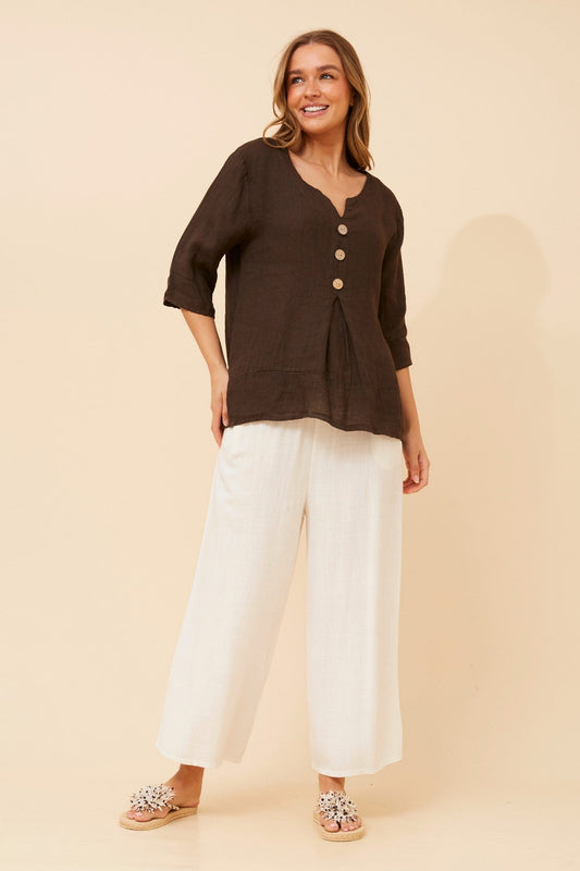 Image of a model wearing Tops. Product name - ETNA SOLID LINEN TOP in Bitter Chocolate colour by brand - BOTTEGA MODA