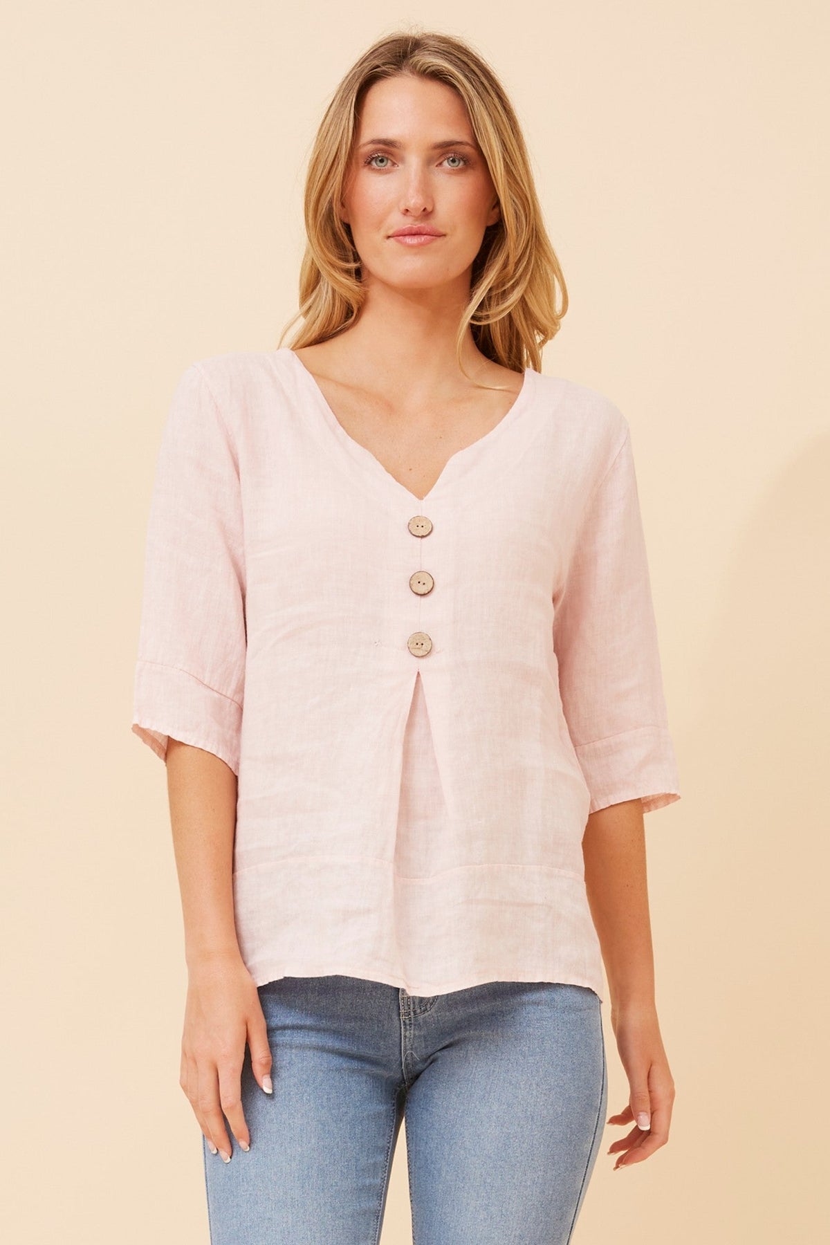 Image of a model wearing Tops. Product name - ETNA SOLID LINEN TOP in Light Pink colour by brand - BOTTEGA MODA