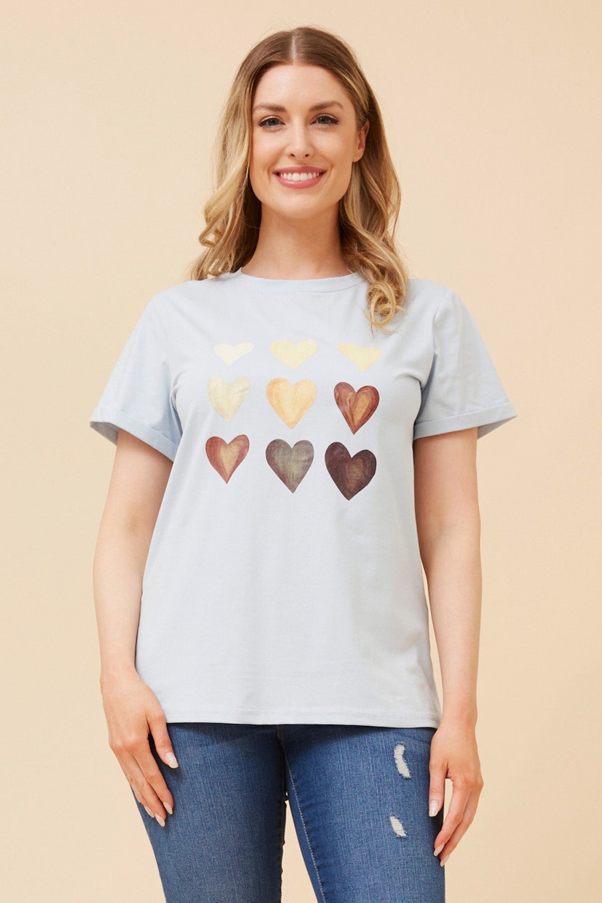Image of a model wearing Tops. Product name - LURA HEART PRINT TSHIRT in Navy colour by brand - Caroline Morgan Australia