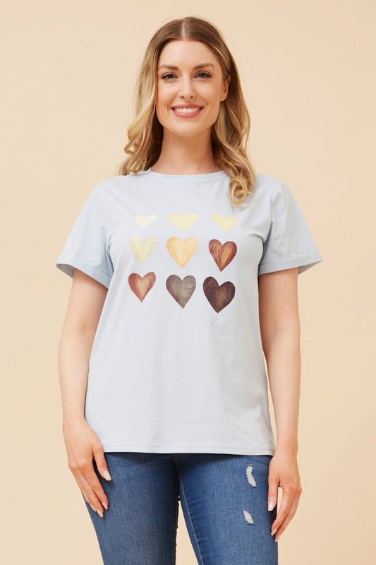 Image of a model wearing Tops. Product name - LURA HEART PRINT TSHIRT in Navy colour by brand - Caroline Morgan Australia