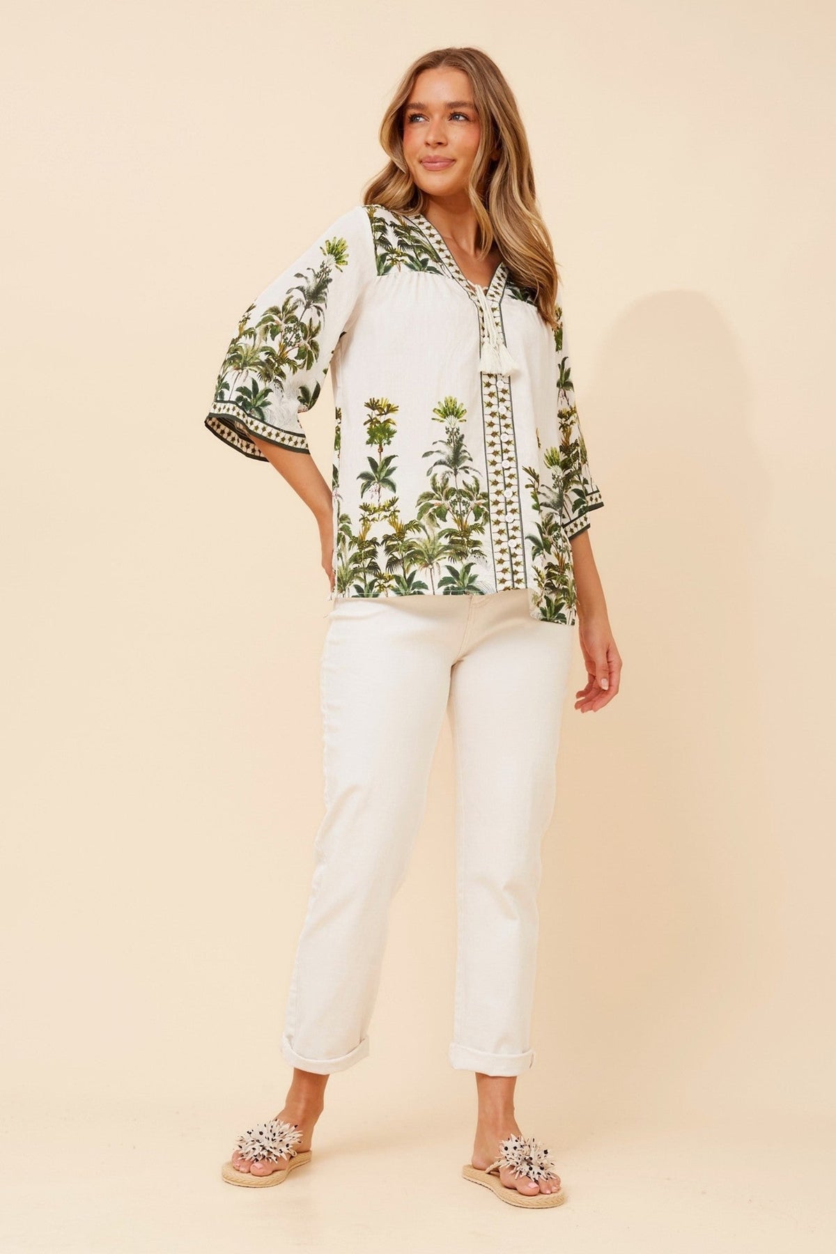 Image of a model wearing Tops. Product name - GERTA TROPICAL PRINT TOP in Multi Green colour by brand - Caroline Morgan Australia