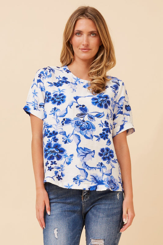 Image of a model wearing Tops. Product name - OSMOND FLORAL TOP in Multi Blue colour by brand - Caroline Morgan Australia