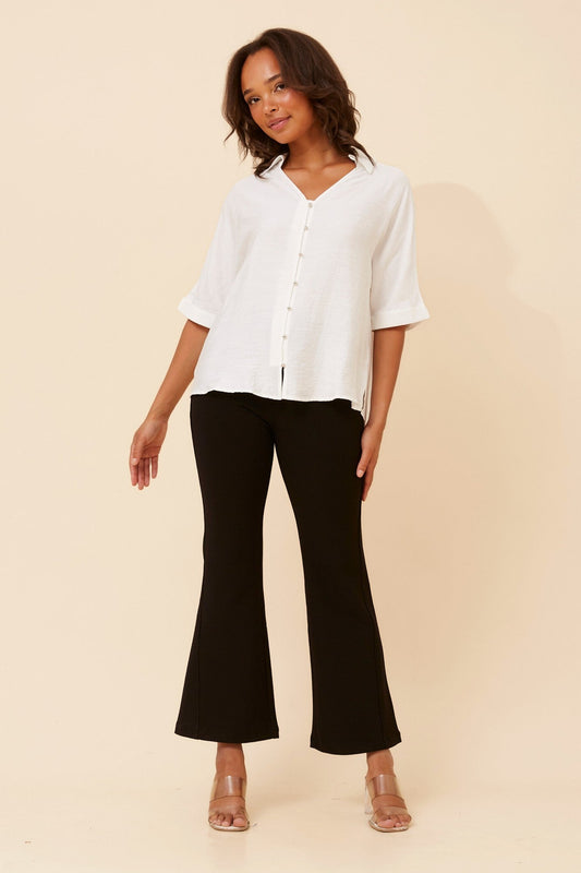 Image of a model wearing Tops. Product name - ZENAIDA SOLID TOP in White colour by brand - Caroline Morgan Australia