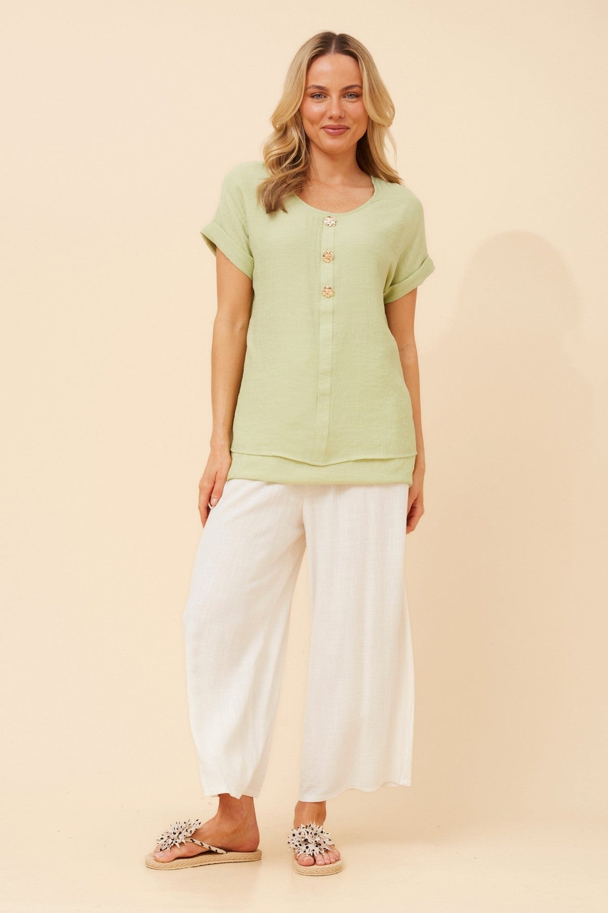 Image of a model wearing Tops. Product name - JAYCEE SOLID TOP in Avocado colour by brand - Caroline Morgan Australia