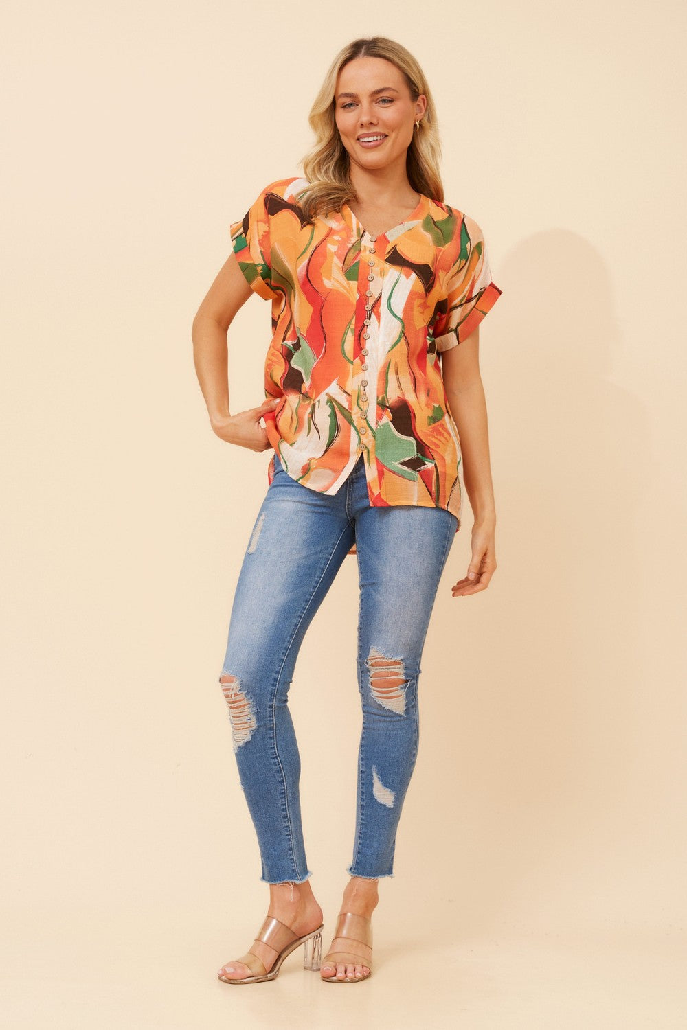 Image of a model wearing Tops. Product name - BELLA ABSTRACT PRINT TOP in Orange colour by brand - Caroline Morgan Australia
