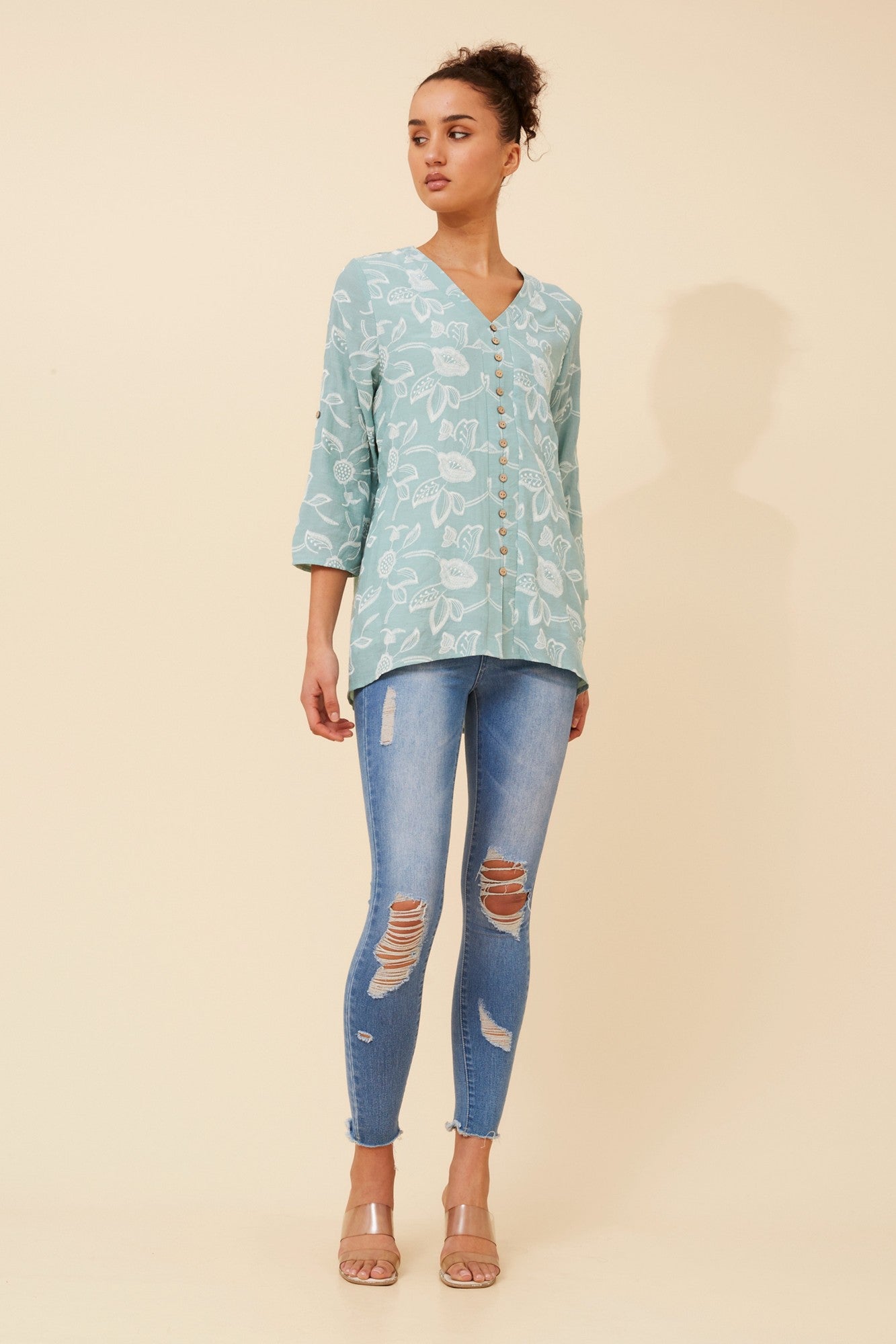 Image of a model wearing Tops. Product name - RUBY FLORAL TOP in Mint colour by brand - Caroline Morgan Australia