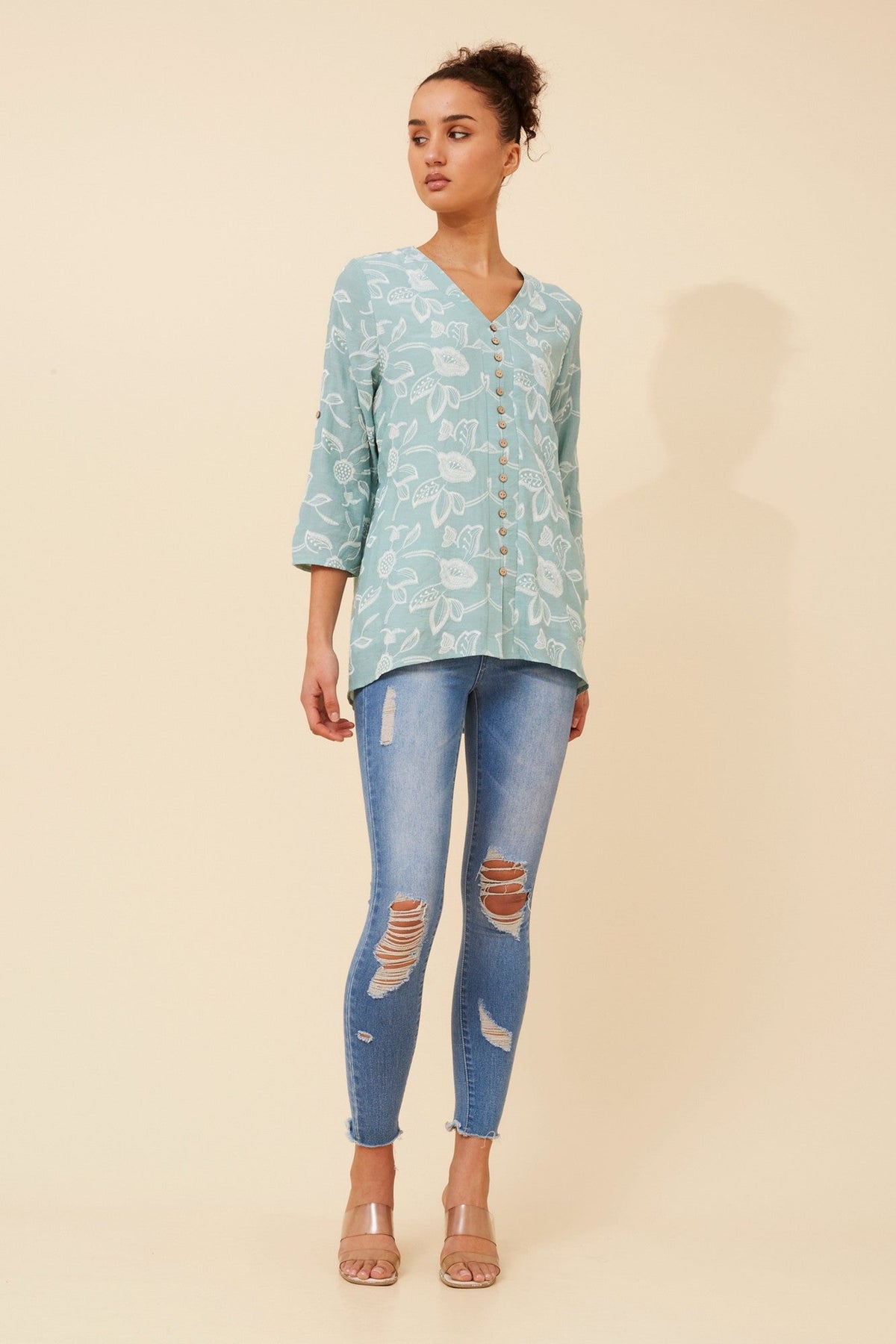 Image of a model wearing Tops. Product name - RUBY FLORAL TOP in Mint colour by brand - Caroline Morgan Australia