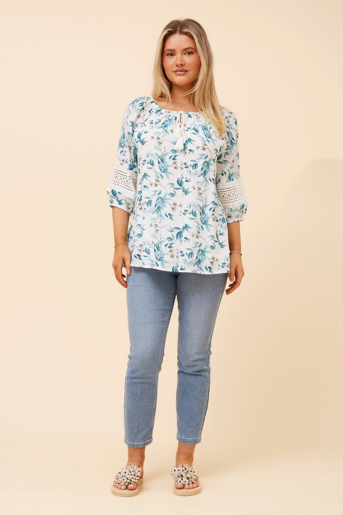Image of a model wearing Tops. Product name - ANDREA LEAF PRINT TOP in Teal colour by brand - Caroline Morgan Australia