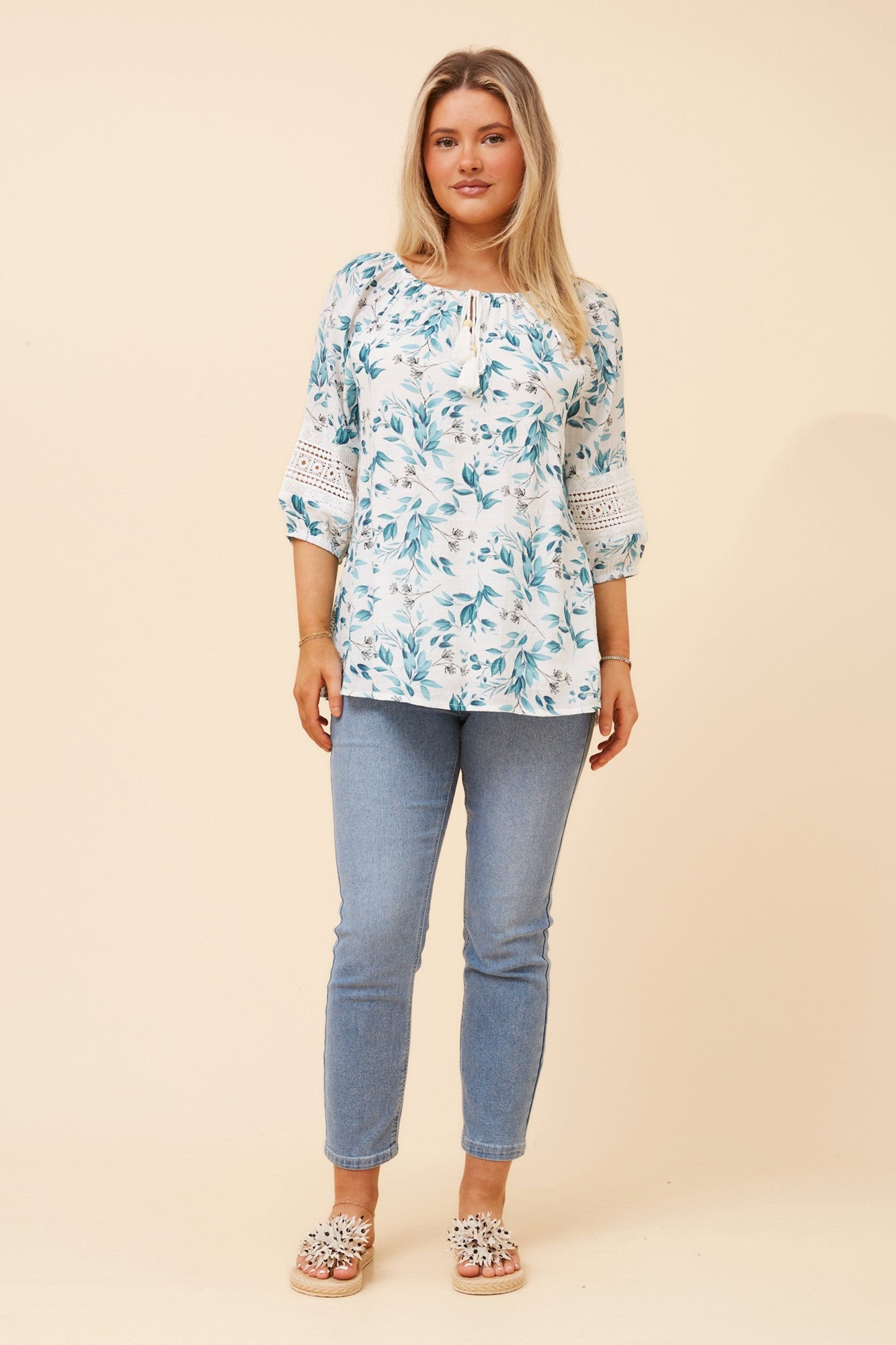 Image of a model wearing Tops. Product name - ANDREA LEAF PRINT TOP in Teal colour by brand - Caroline Morgan Australia