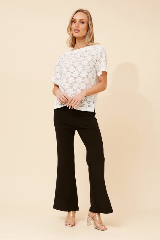 Image of a model wearing Tops. Product name - HARWIN LACE TOP in Black colour by brand - Caroline Morgan Australia