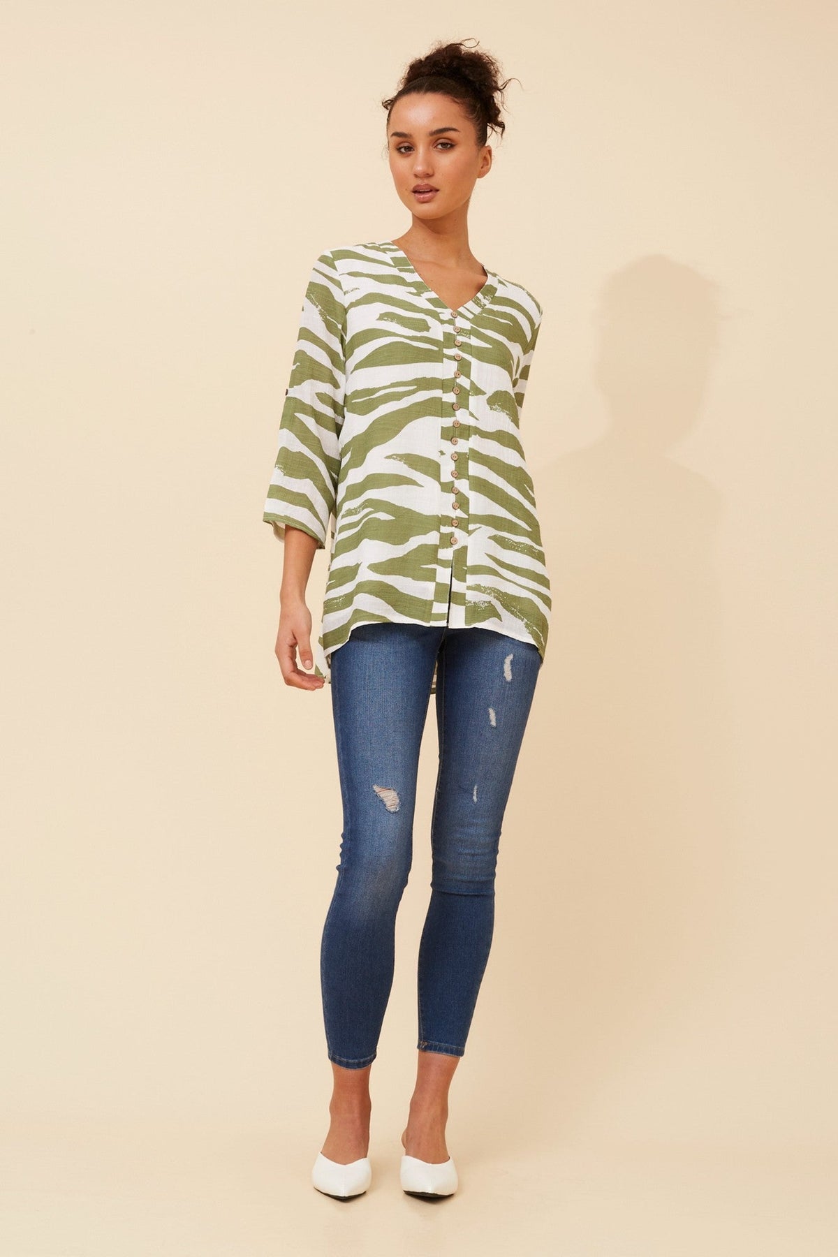 Image of a model wearing Tops. Product name - RUBY ABSTRACT PRINT TOP in Khaki colour by brand - Caroline Morgan Australia