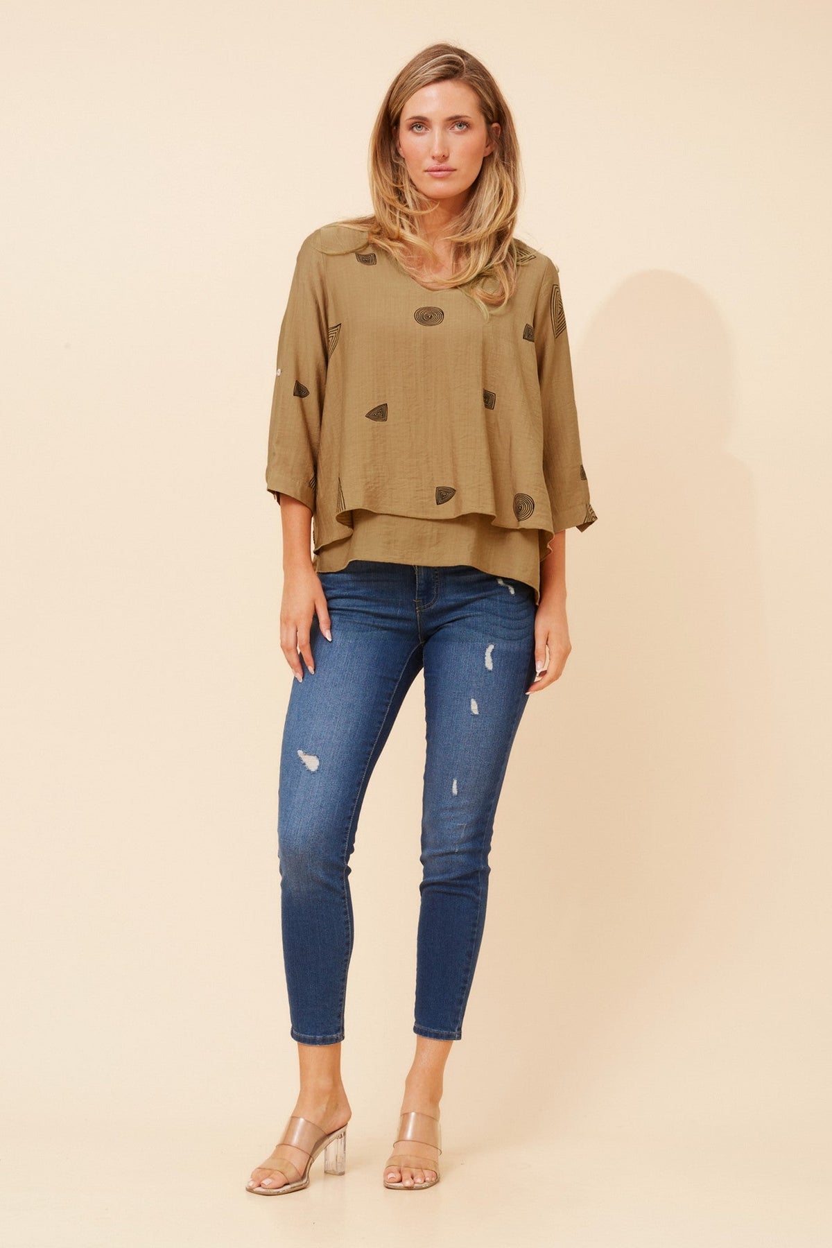 Image of a model wearing Tops. Product name - LORETO ABSTRACT PRINT TOP in Toffee colour by brand - Caroline Morgan Australia