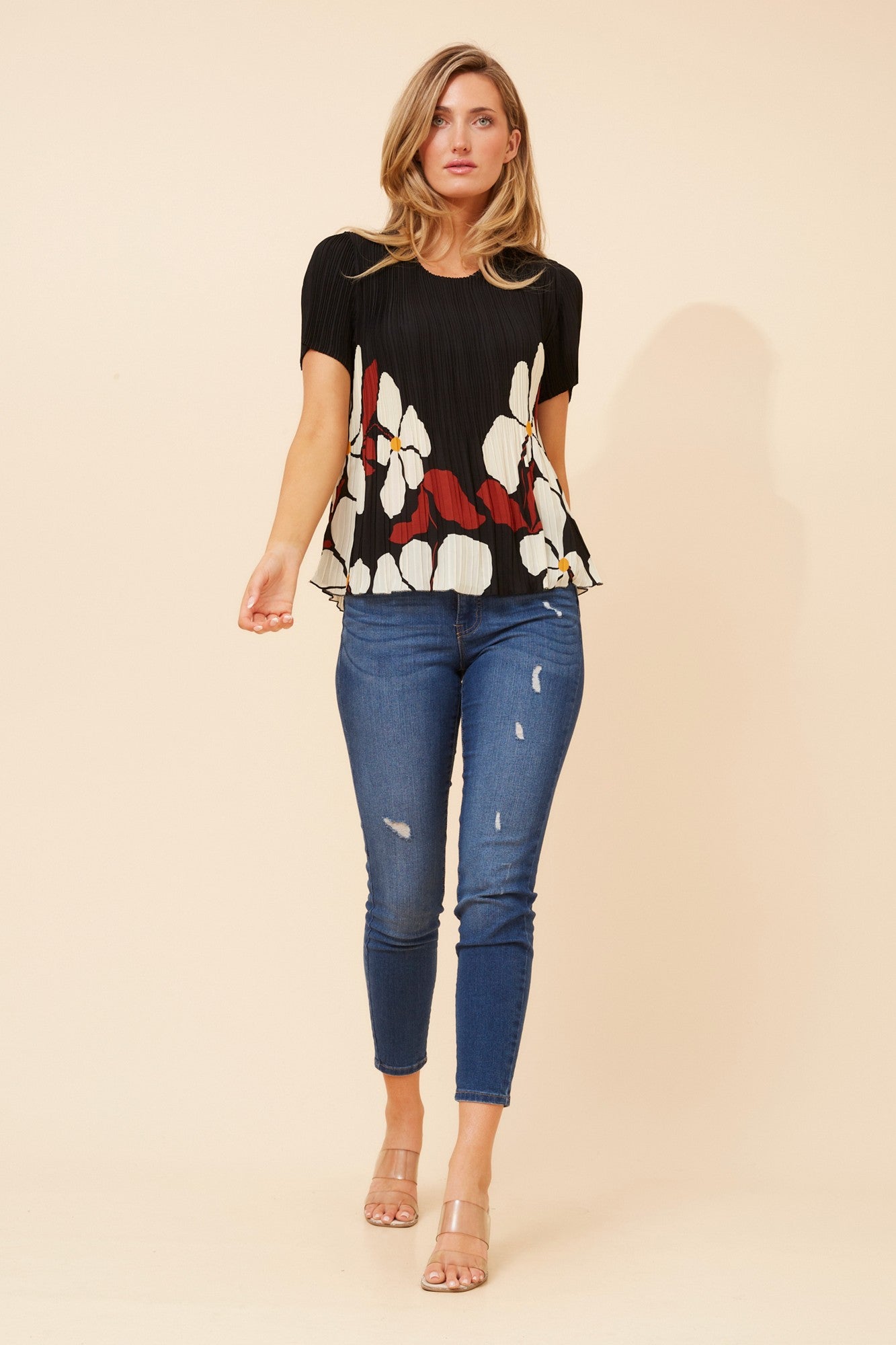 Image of a model wearing Tops. Product name - JIMELLA FLORAL PLEATED TOP in Black colour by brand - Caroline Morgan Australia