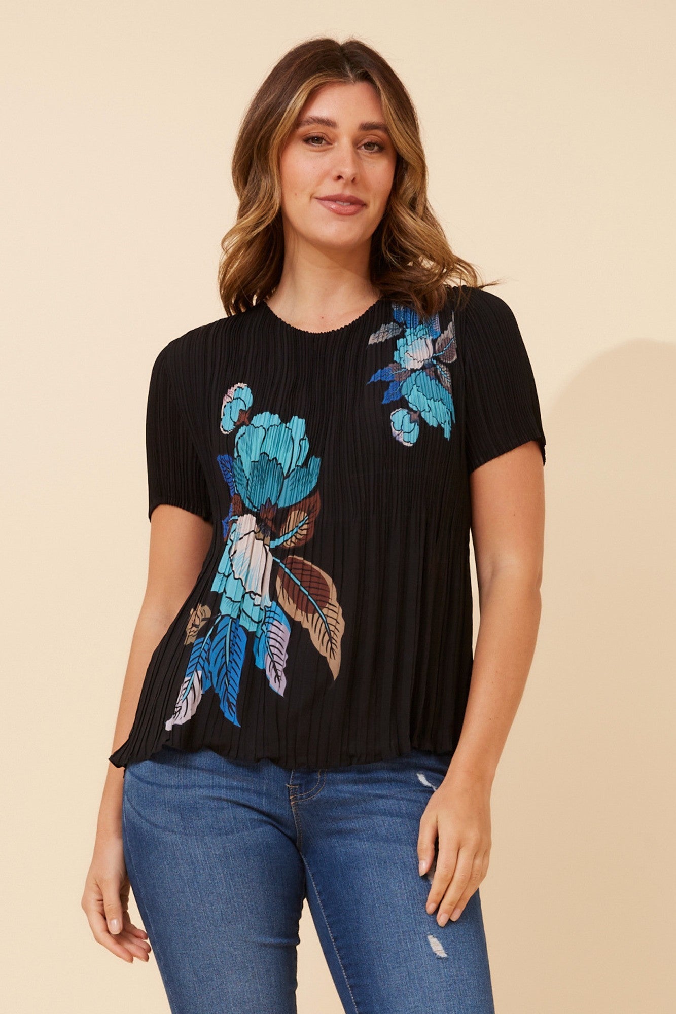 Image of a model wearing Tops. Product name - JIMELLA FLORAL PLEATED TOP in Blue colour by brand - Caroline Morgan Australia