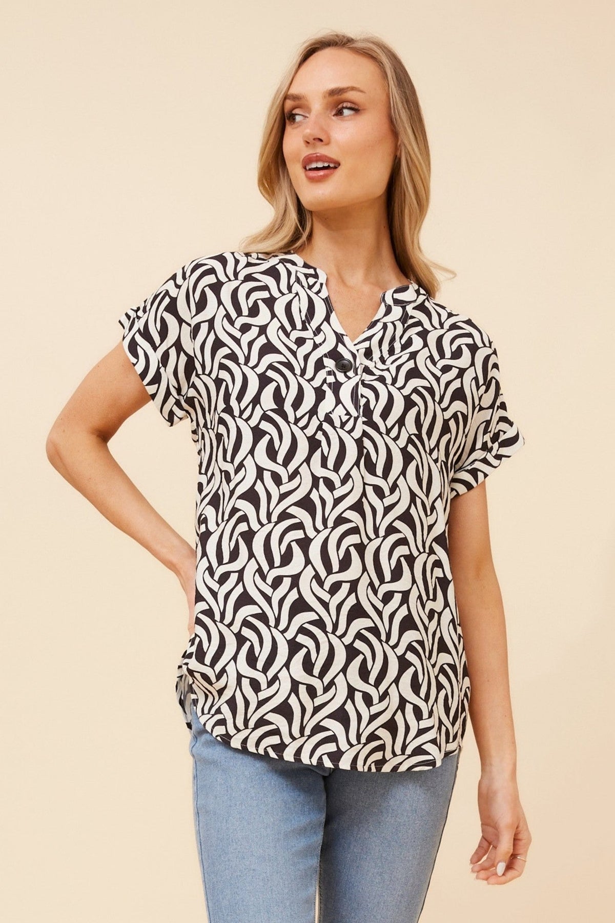 Image of a model wearing Tops. Product name - GWIN ABSTRACT PRINT TOP in White And Black colour by brand - Caroline Morgan Australia