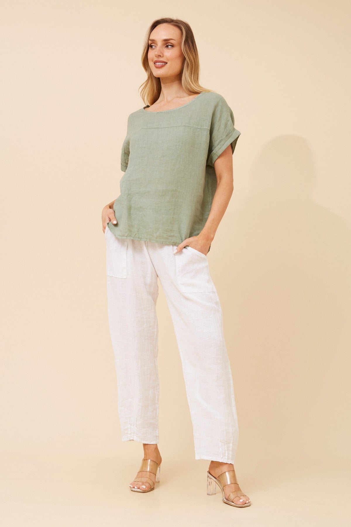 Image of a model wearing Tops. Product name - LEORA SOLID LINEN TOP in Sage colour by brand - BOTTEGA MODA