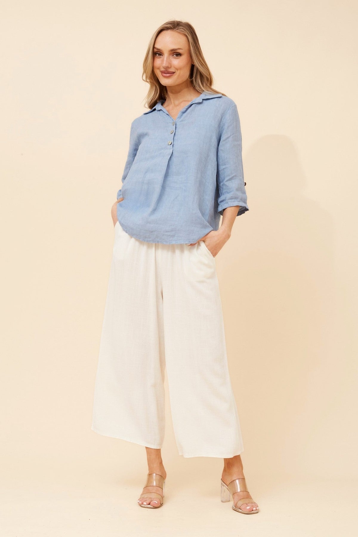 Image of a model wearing Tops. Product name - ARMIDA SOLID LINEN TOP in Khaki colour by brand - BOTTEGA MODA