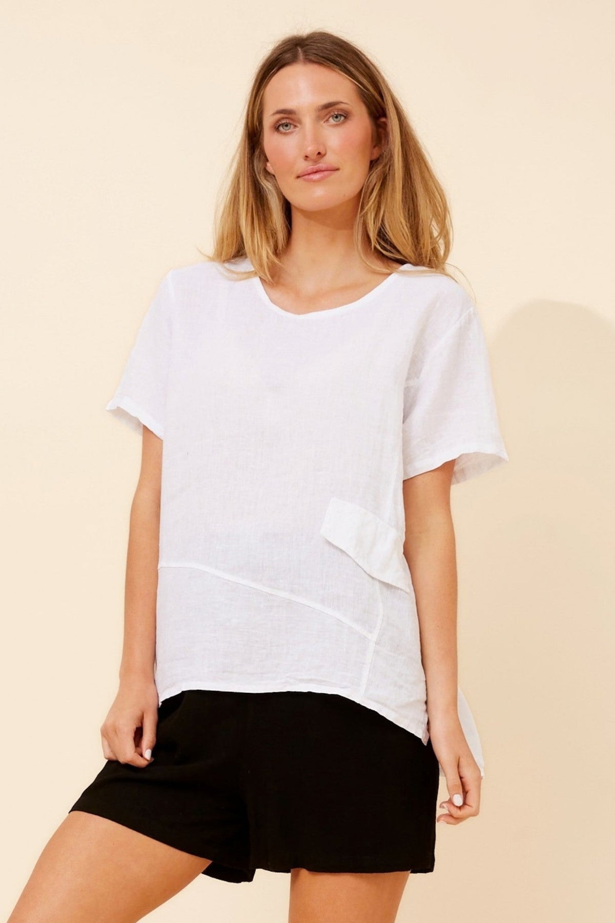 Image of a model wearing Tops. Product name - ONA SOLID LINEN TOP in White colour by brand - BOTTEGA MODA