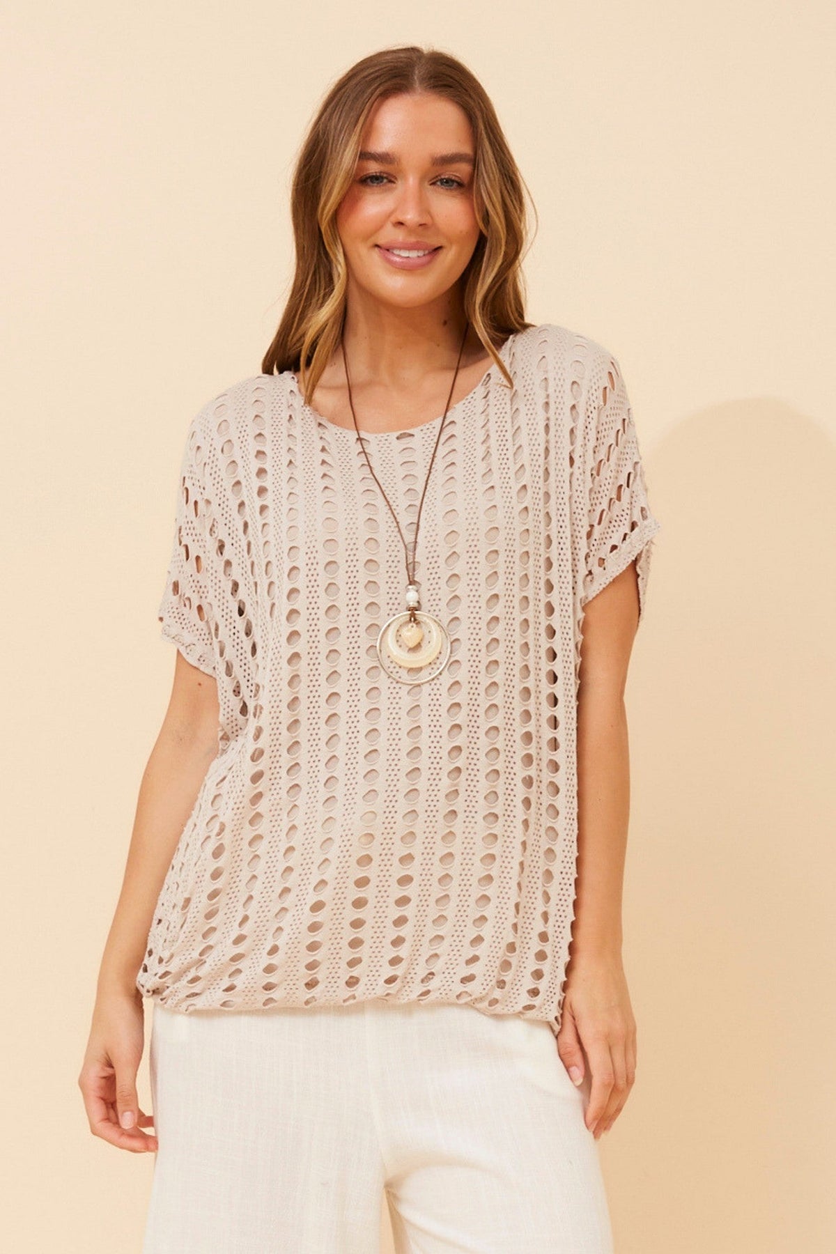 Image of a model wearing Tops. Product name - ENRIKA EYELET TOP in Nougat colour by brand - BOTTEGA MODA