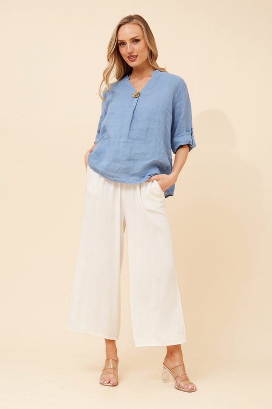 Image of a model wearing Tops. Product name - GREGORIA SOLID LINEN TOP in Denim colour by brand - BOTTEGA MODA