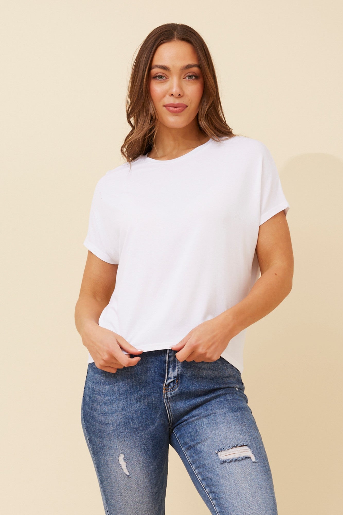 Image of a model wearing Tops. Product name - JILLIE SHORT SLEEVE TSHIRT in Rich Red colour by brand - Caroline Morgan Australia