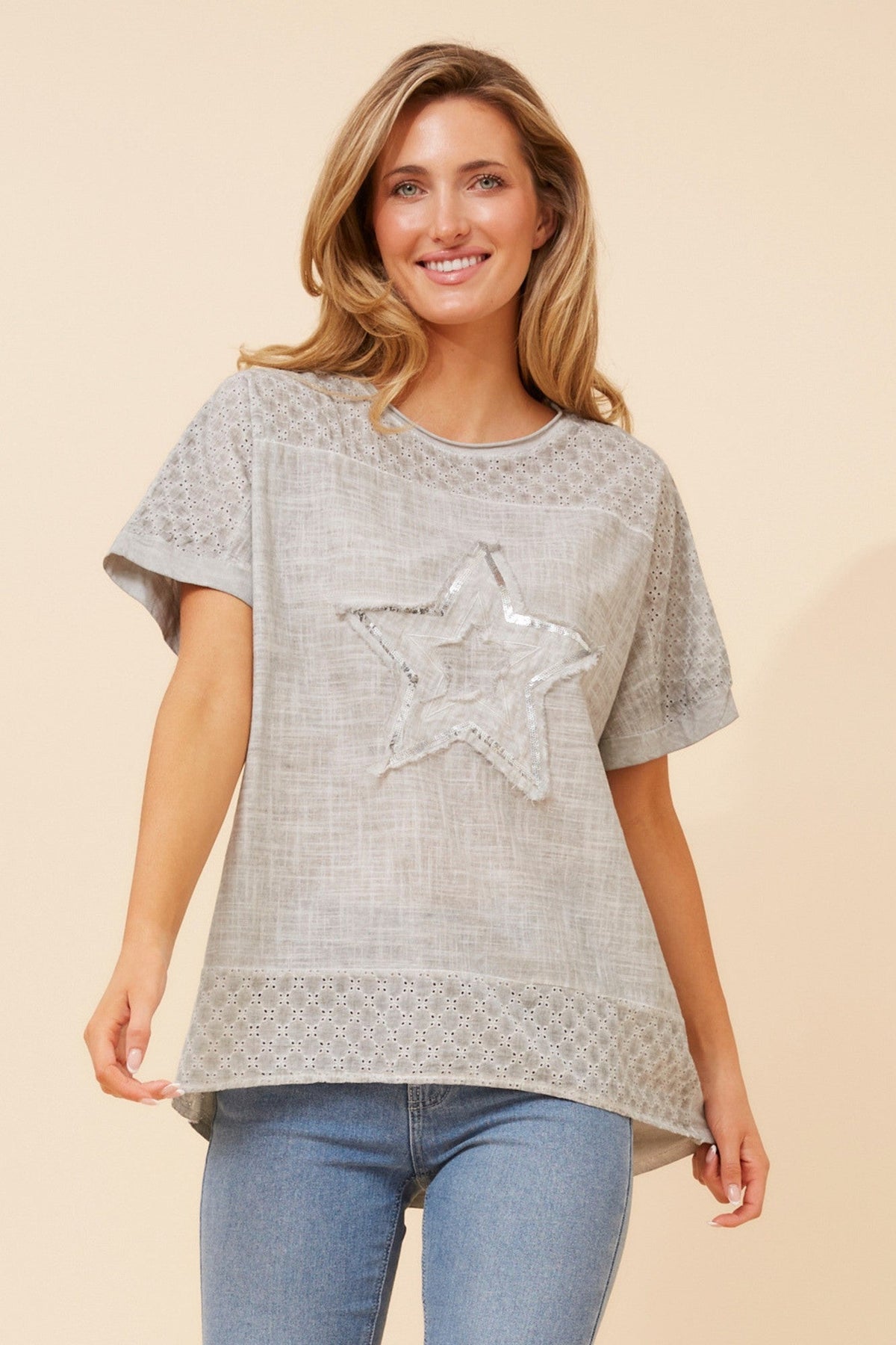 Image of a model wearing Tops. Product name - DRAI SEQUIN STAR TOP in Light Blue colour by brand - Caroline Morgan Australia